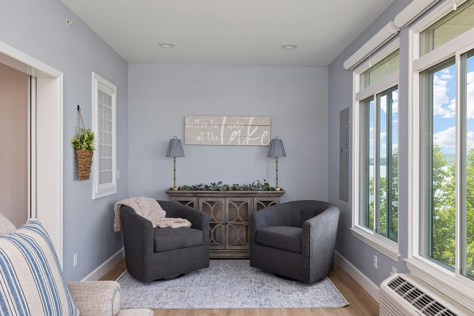 holly-jones-signature-homes-branson-mo-prep-for-design-consultation-sunroom-porch-sitting-area-upholstered-chairs-and-console-table-by-windows-delight.jpg