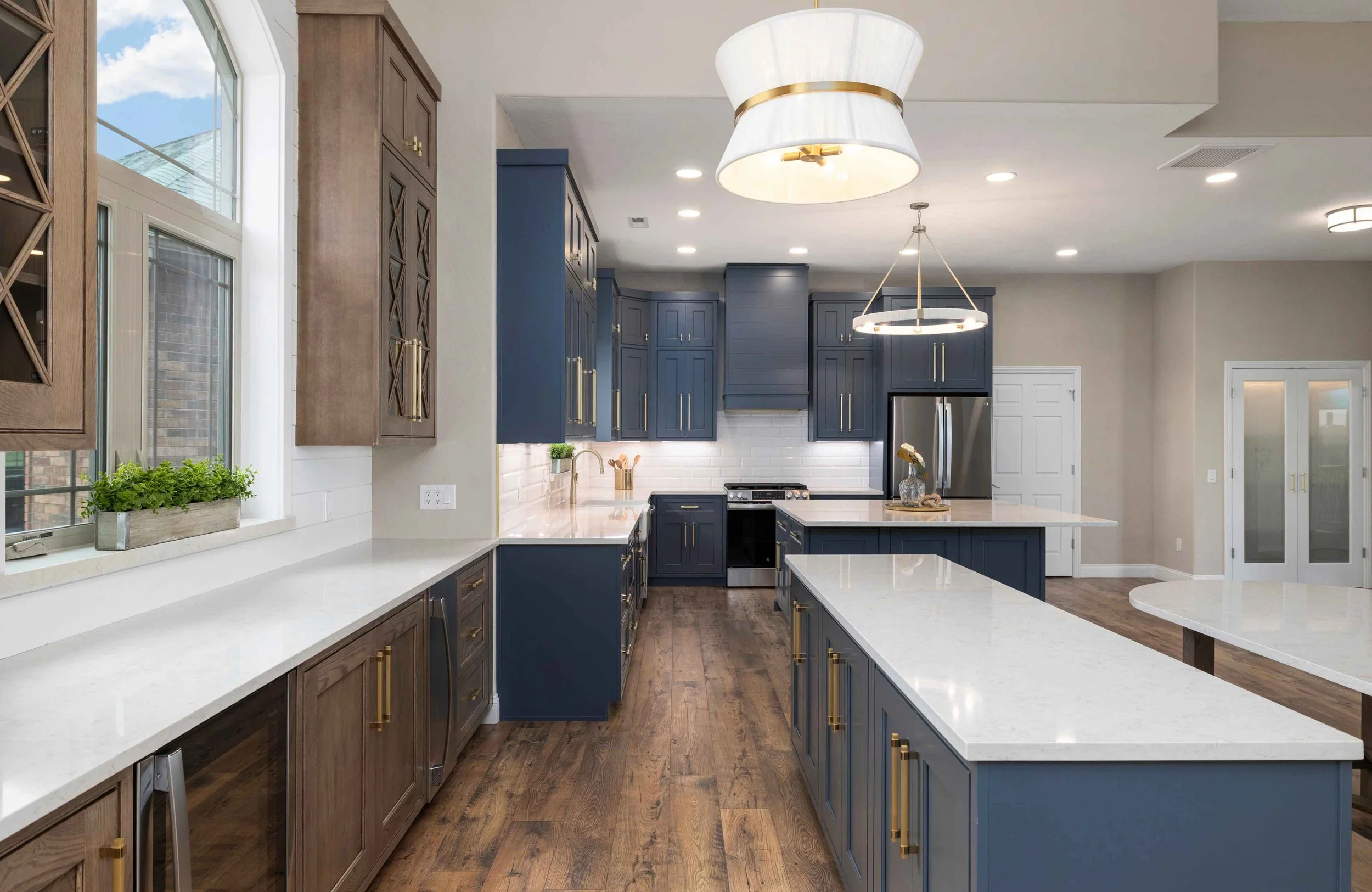 full-service-interior-design-blue-eye-mo-full-gut-renovation-kitchen-with-blue-and-stained-cabinets-white-quartz-countertops-collaborative-home-furnishing.jpg