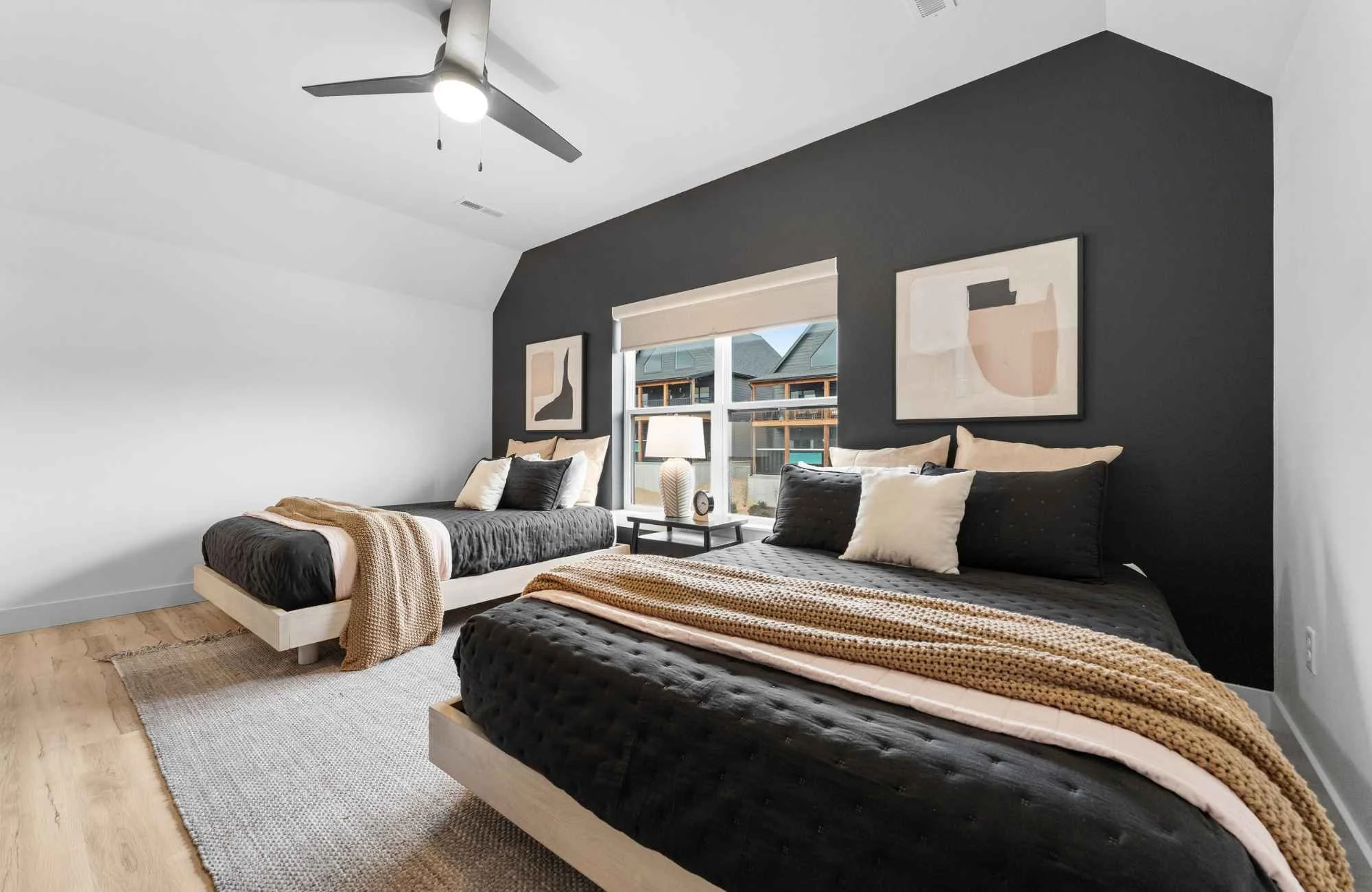 full-service-interior-designer-branson-mo-interior-design-misconceptions-bedroom-with-two-queen-beds-black-feature-wall-abstract-art-high-contrast-cozy.jpg
