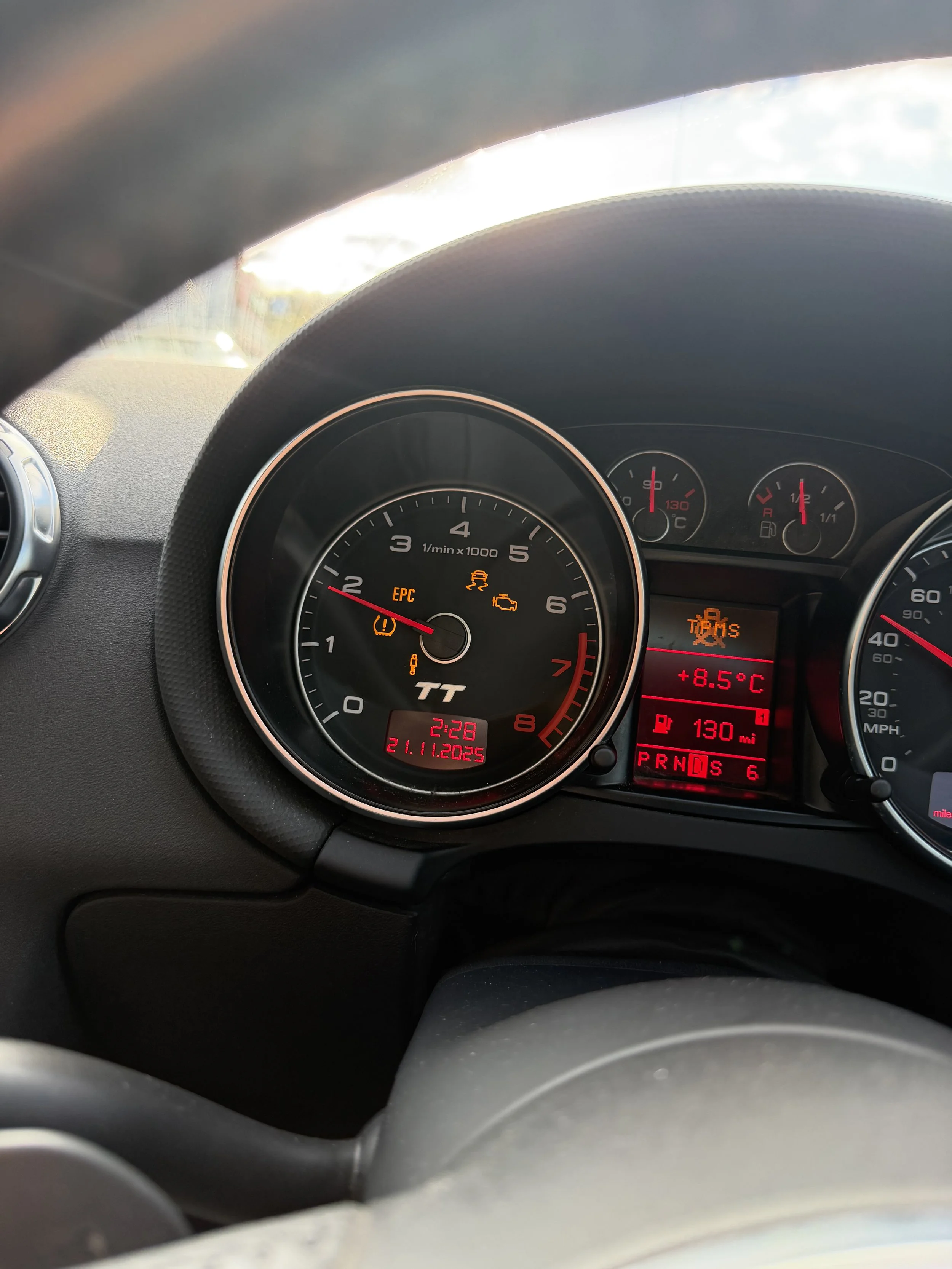 A car dashboard showing the time as 2:28, date as November 21, 2025, with warning lights for tire pressure, EPS, and check engine.