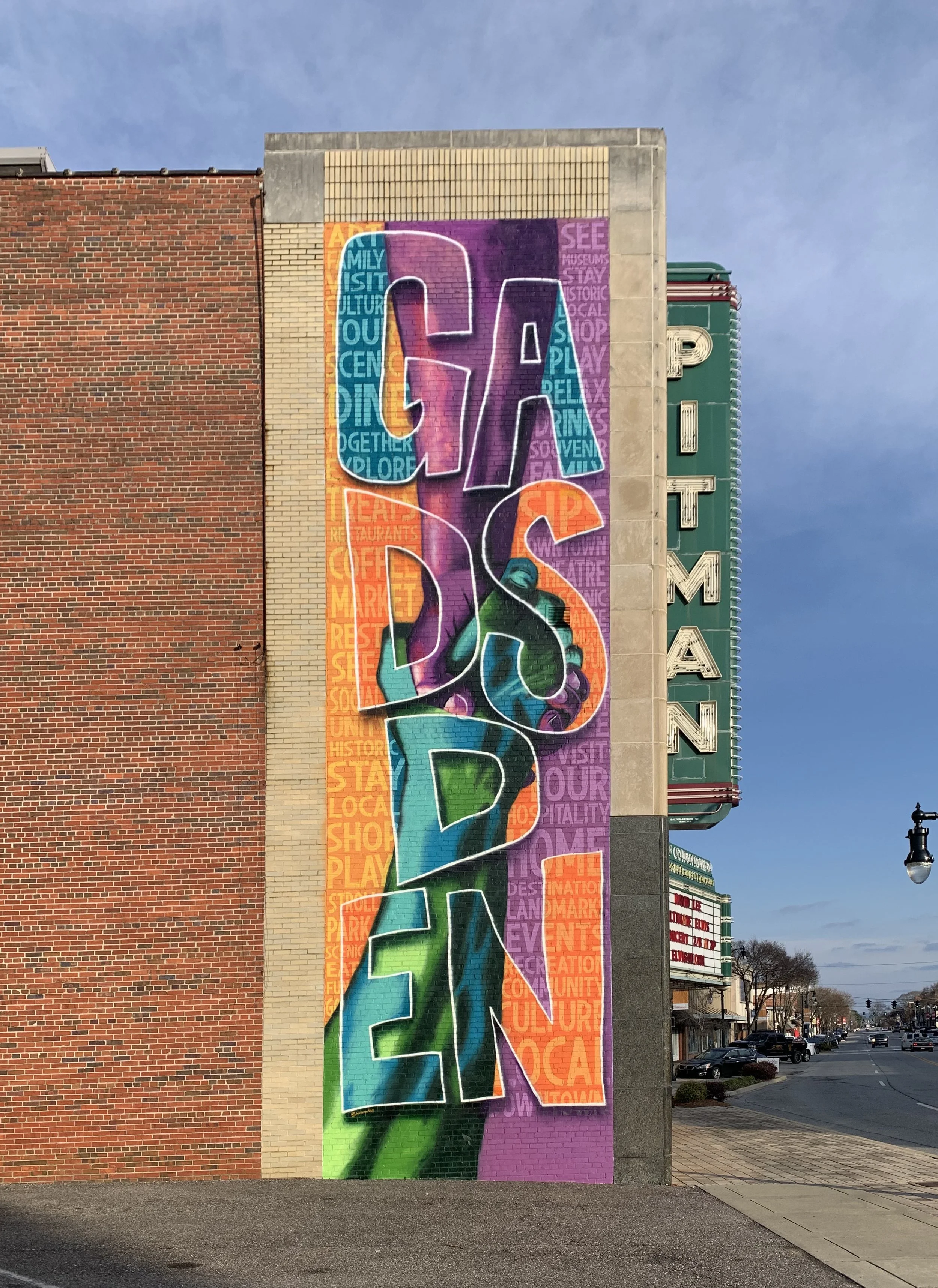Colorful mural on the side of a building that spells out the word 'SERVICE' with vibrant, stylized letters.