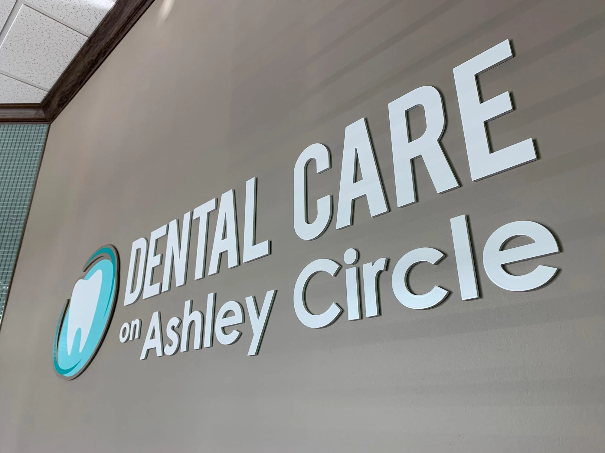 Sign for Dental Care on Ashley Circle with a tooth logo.