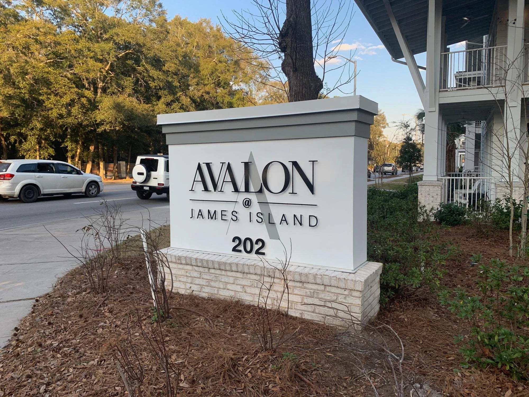 Sign for Avalon at James Island with street and cars in the background.