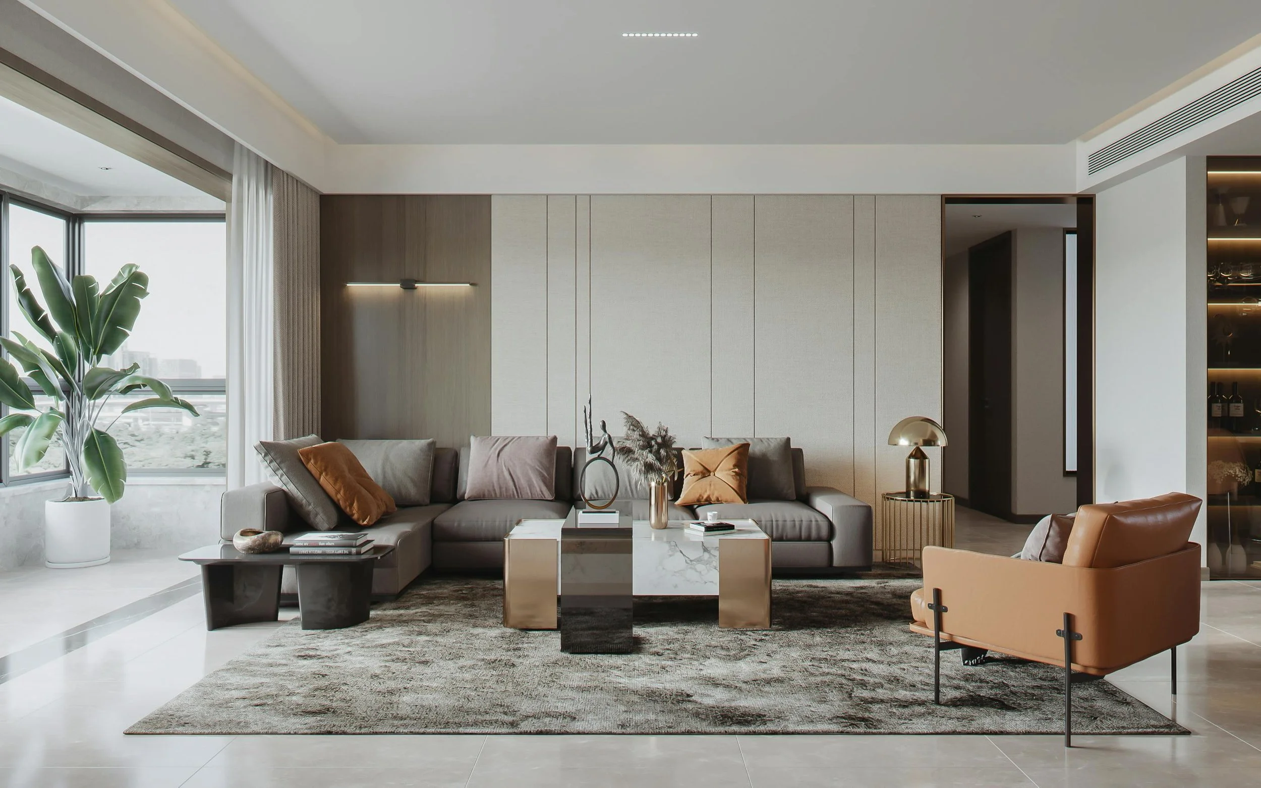 Modern living room with large gray sectional sofa, leather armchair, coffee tables, decorative vases, large window with plant, and a textured area rug.