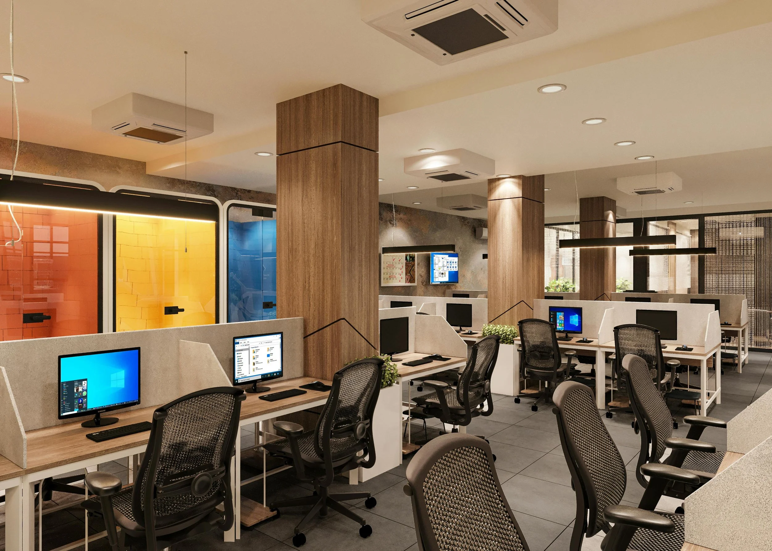 Modern open-concept office with workstations, black mesh office chairs, desktop computers, wood and concrete accents, colorful glass partitions, and hanging light fixtures.