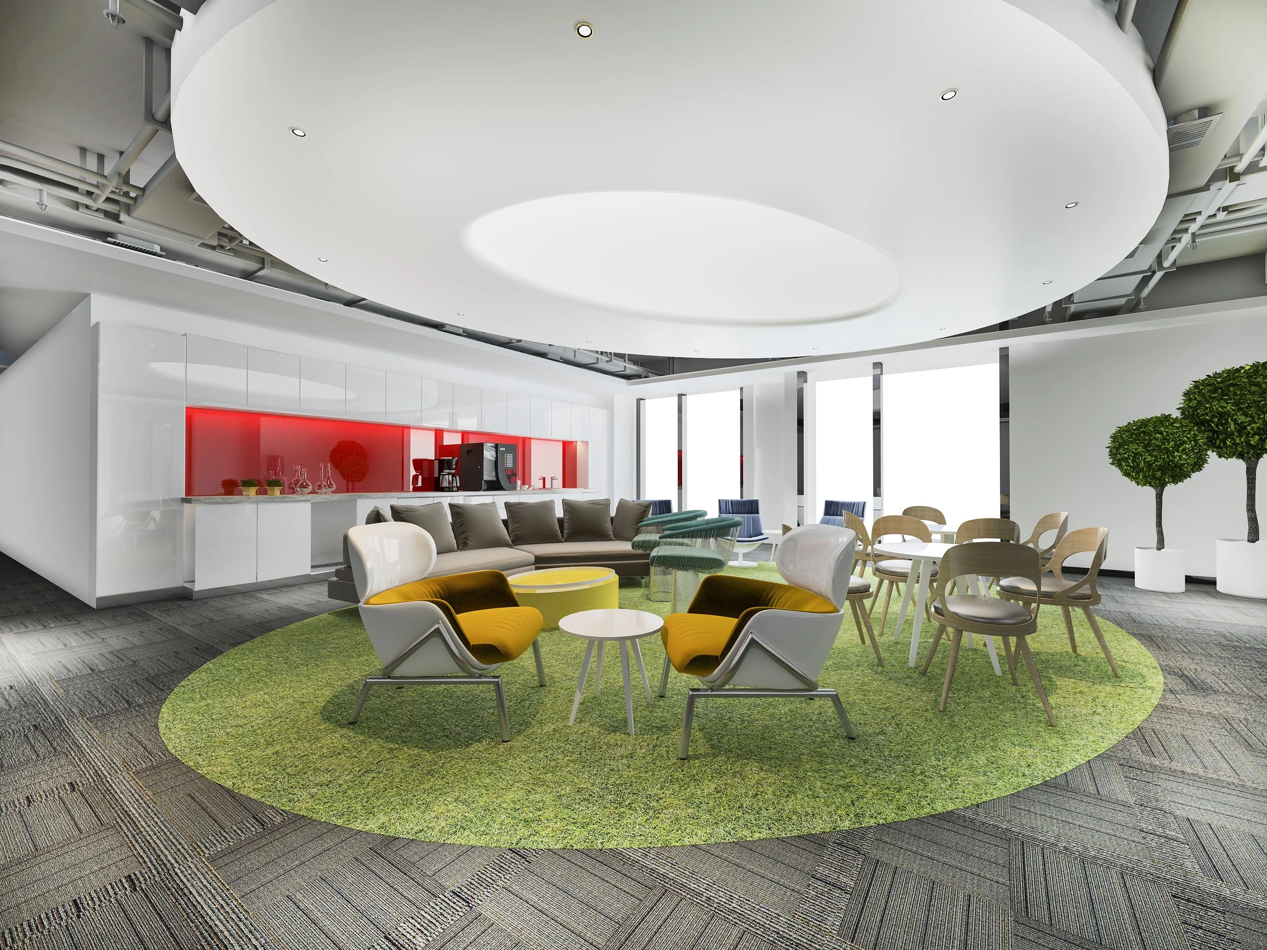 Modern lounge area with green circular rug, yellow and white armchairs, wooden chairs and sofa, large windows with white blinds, potted trees, and a red accent wall with kitchen appliances.