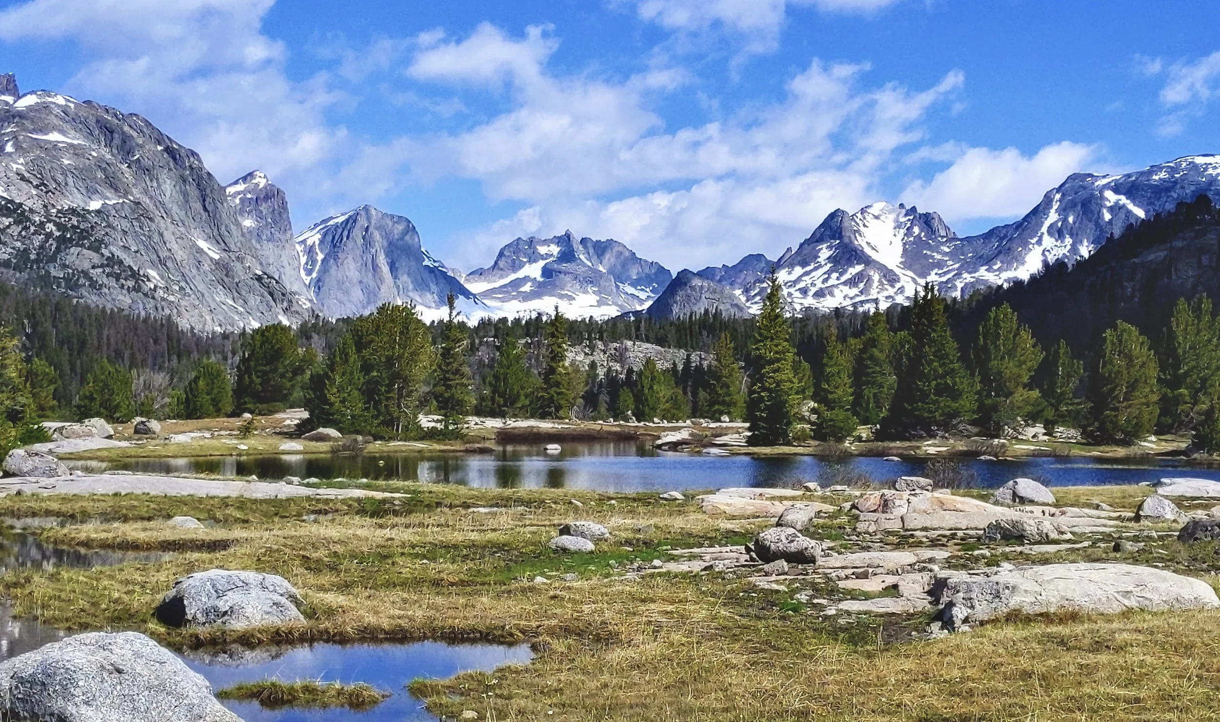 Vast mountain landscape with snowy peaks and lakes