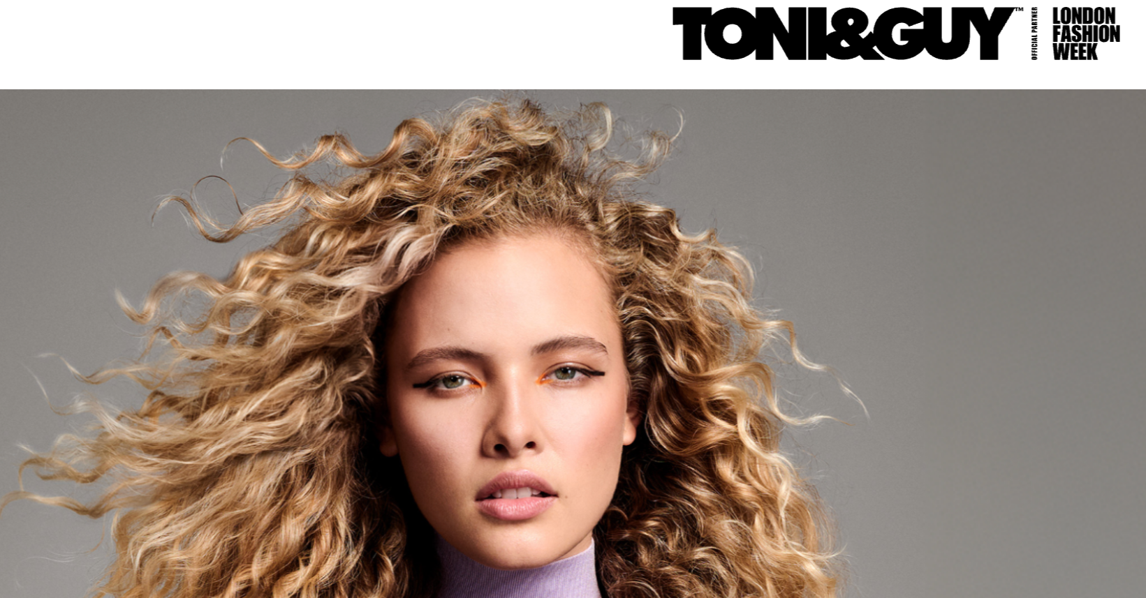 A woman with long blonde curly hair and natural makeup posing against a gray background, with "TONI&GUY" text and the London Fashion Week logo at the top.