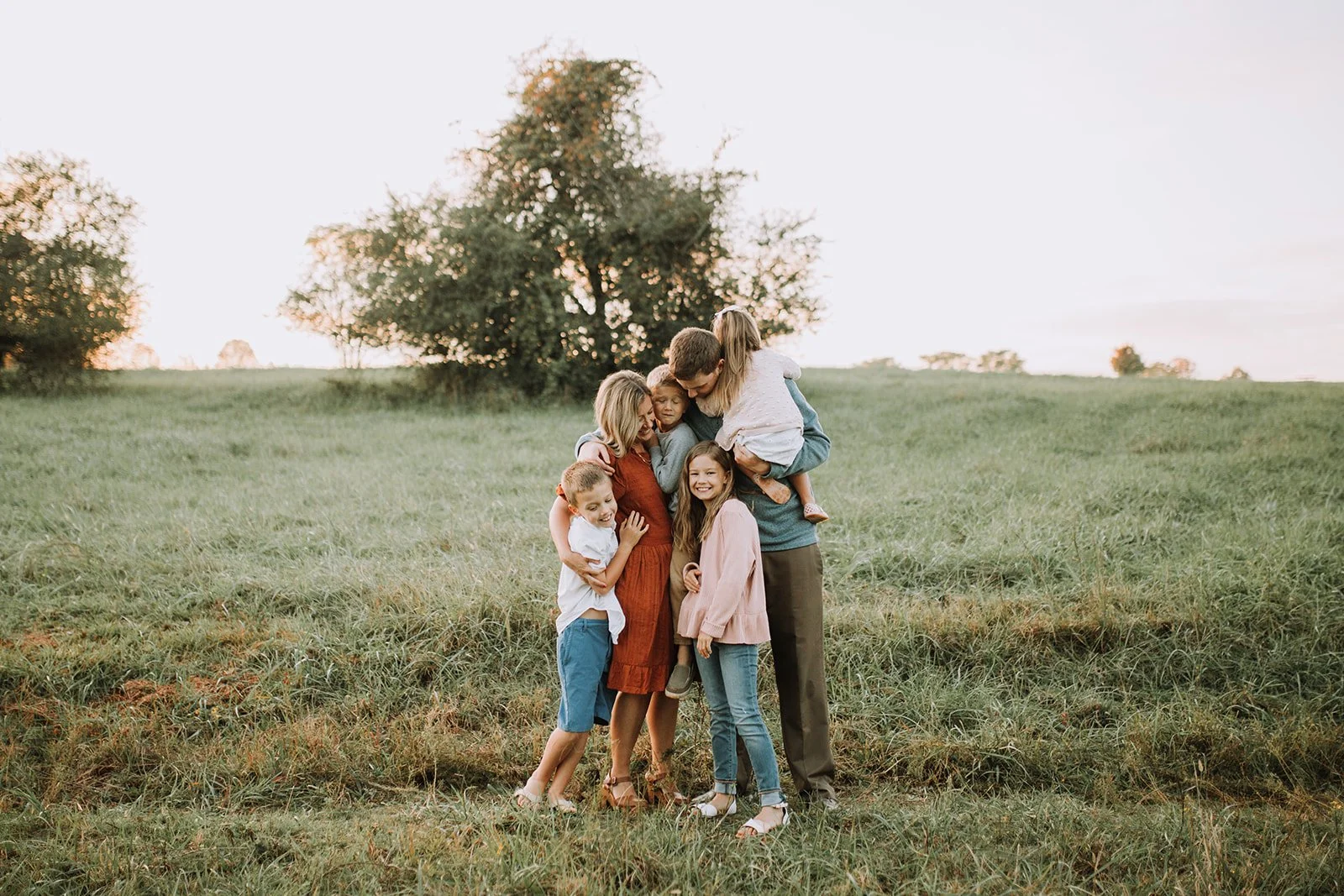 A family gathered in a field in buford georgia at sunset. Photo taken by A+E Photos in Buford Georgia
