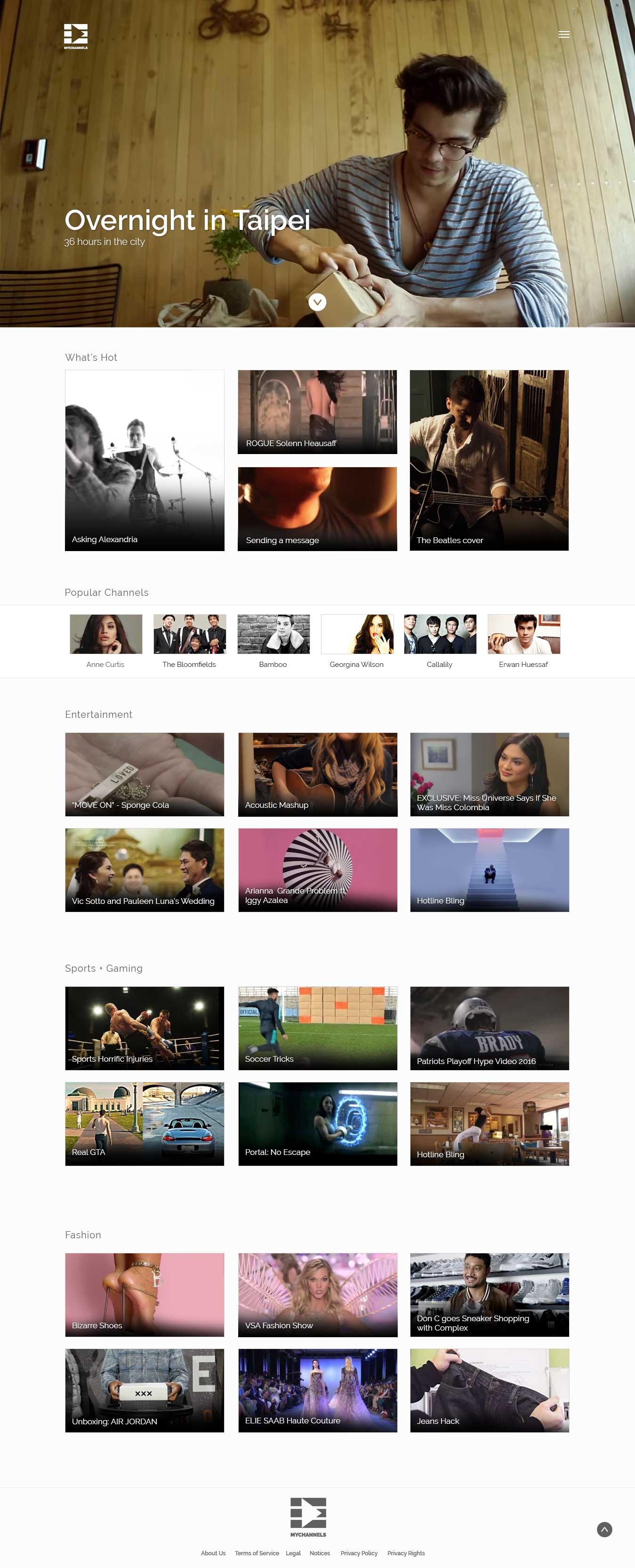 Young man with glasses opening a gift in a cozy, wood-paneled room.