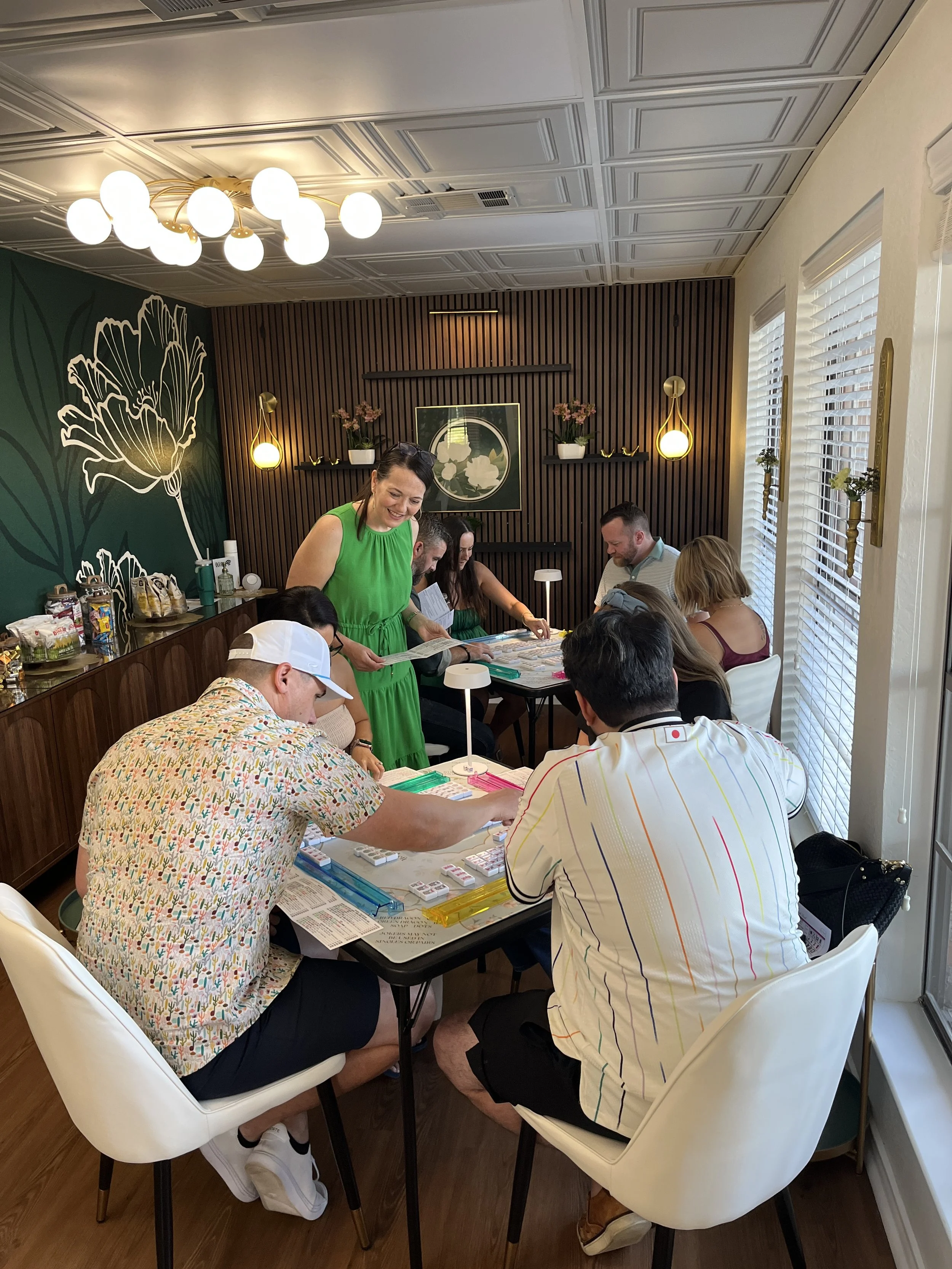mahjong instructor teaching mahjong to men and women