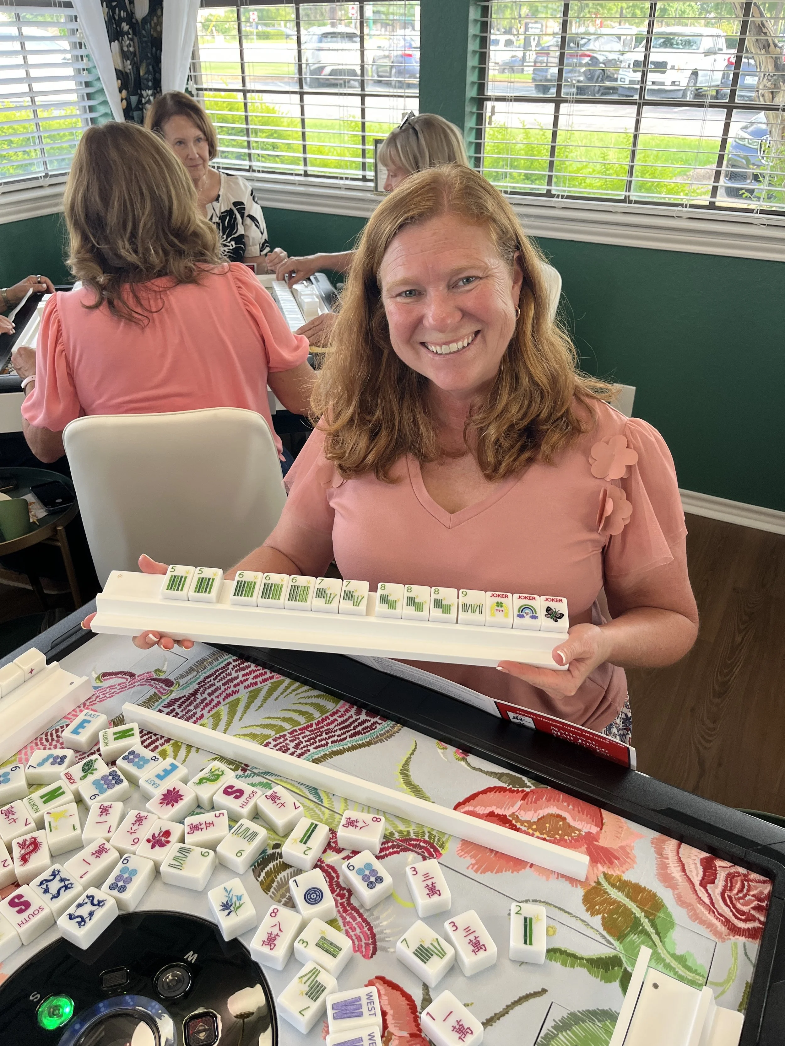 female with red hair playing mahjong