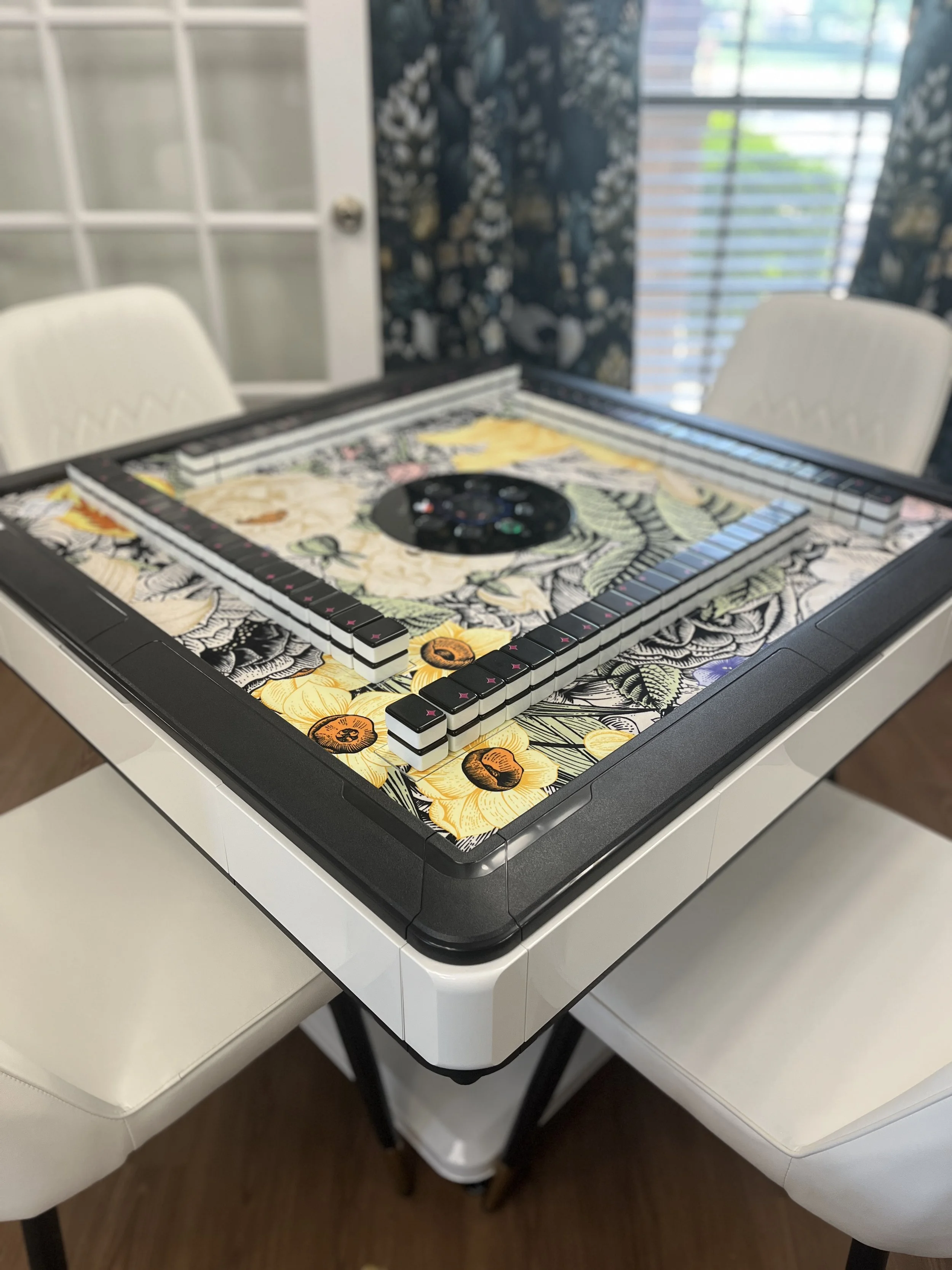automatic mahjong table and chairs in front of a window