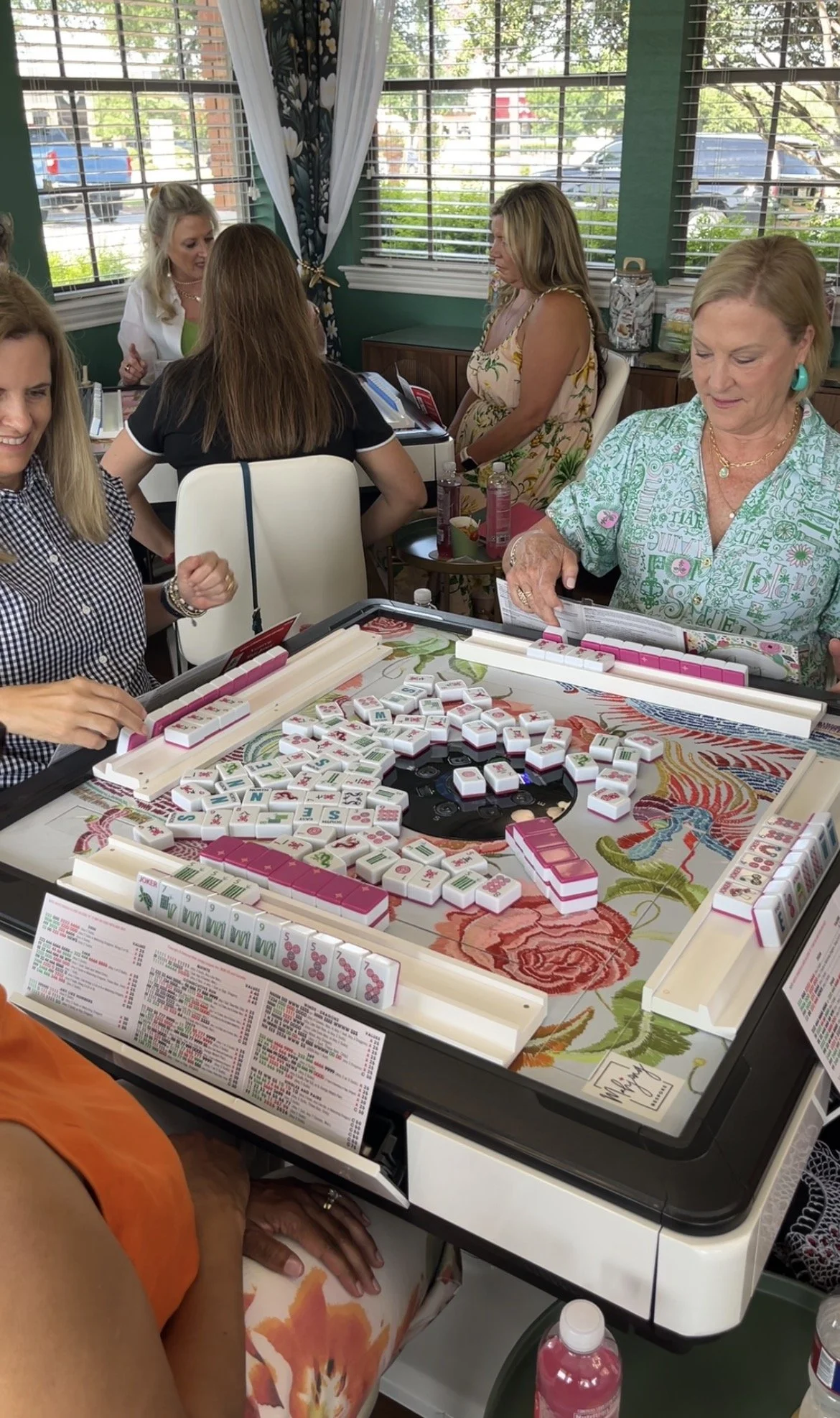 Women playing mahjong at an automatic mahjong table