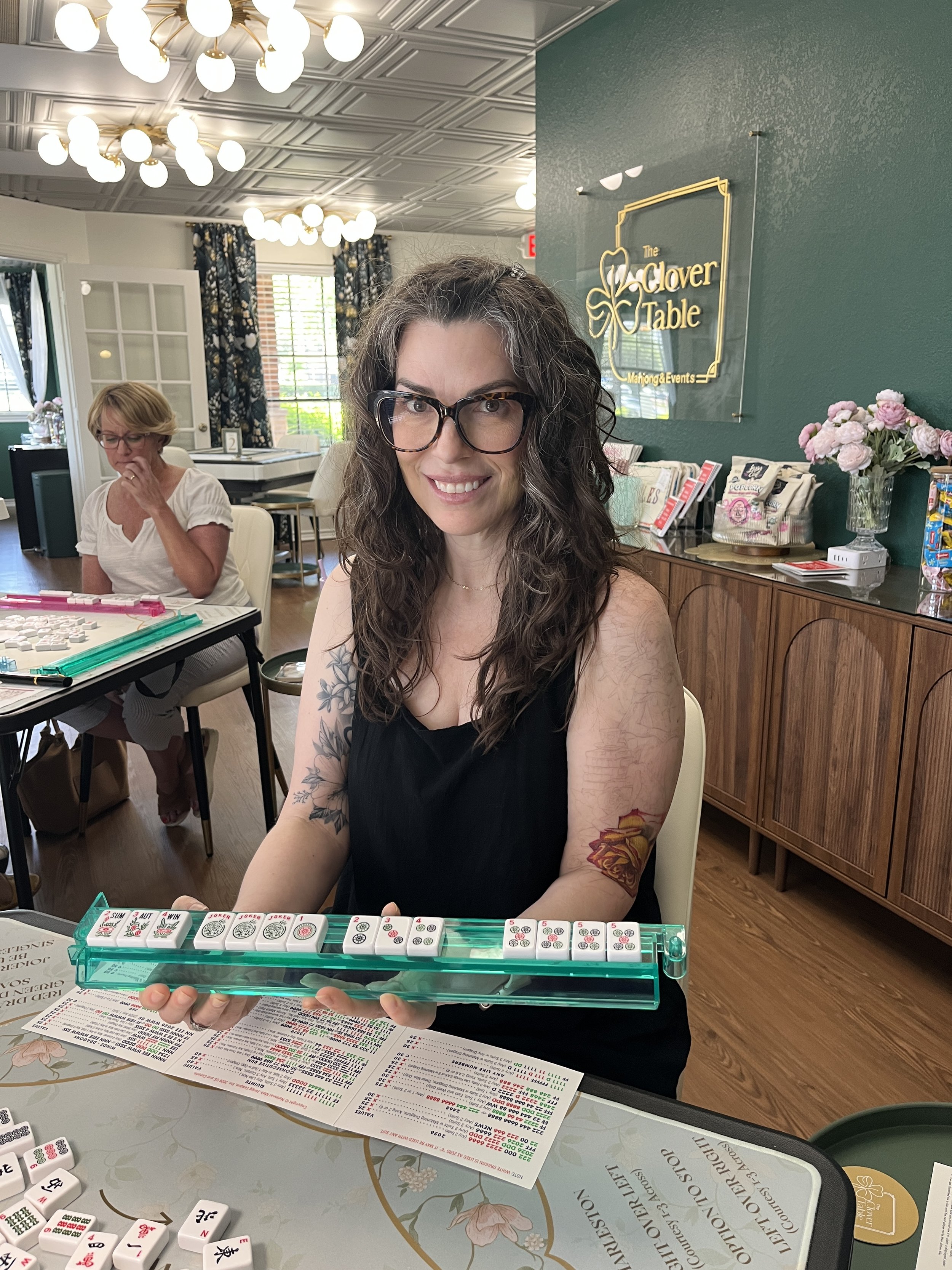 woman holding a mahjong rack