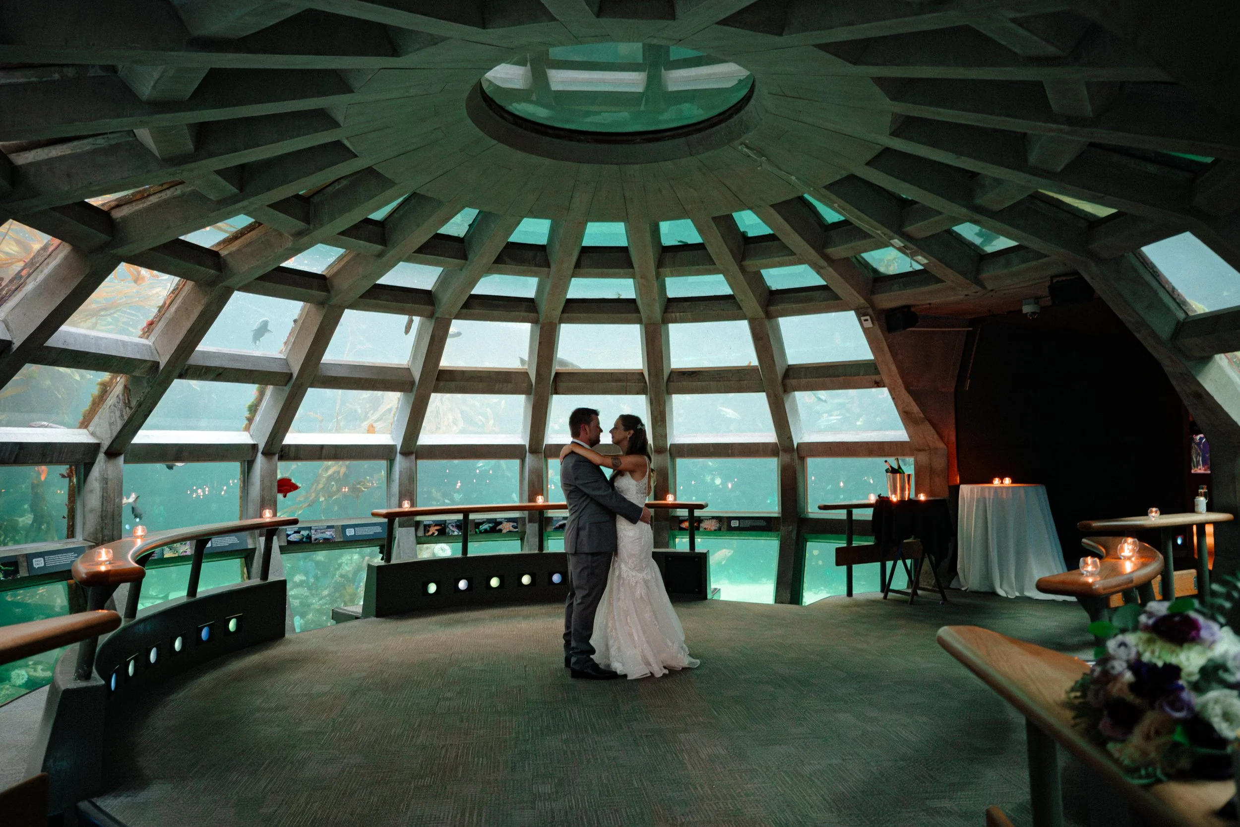 Wedding couple portraits inside the Seattle Aquarium underwater gallery.