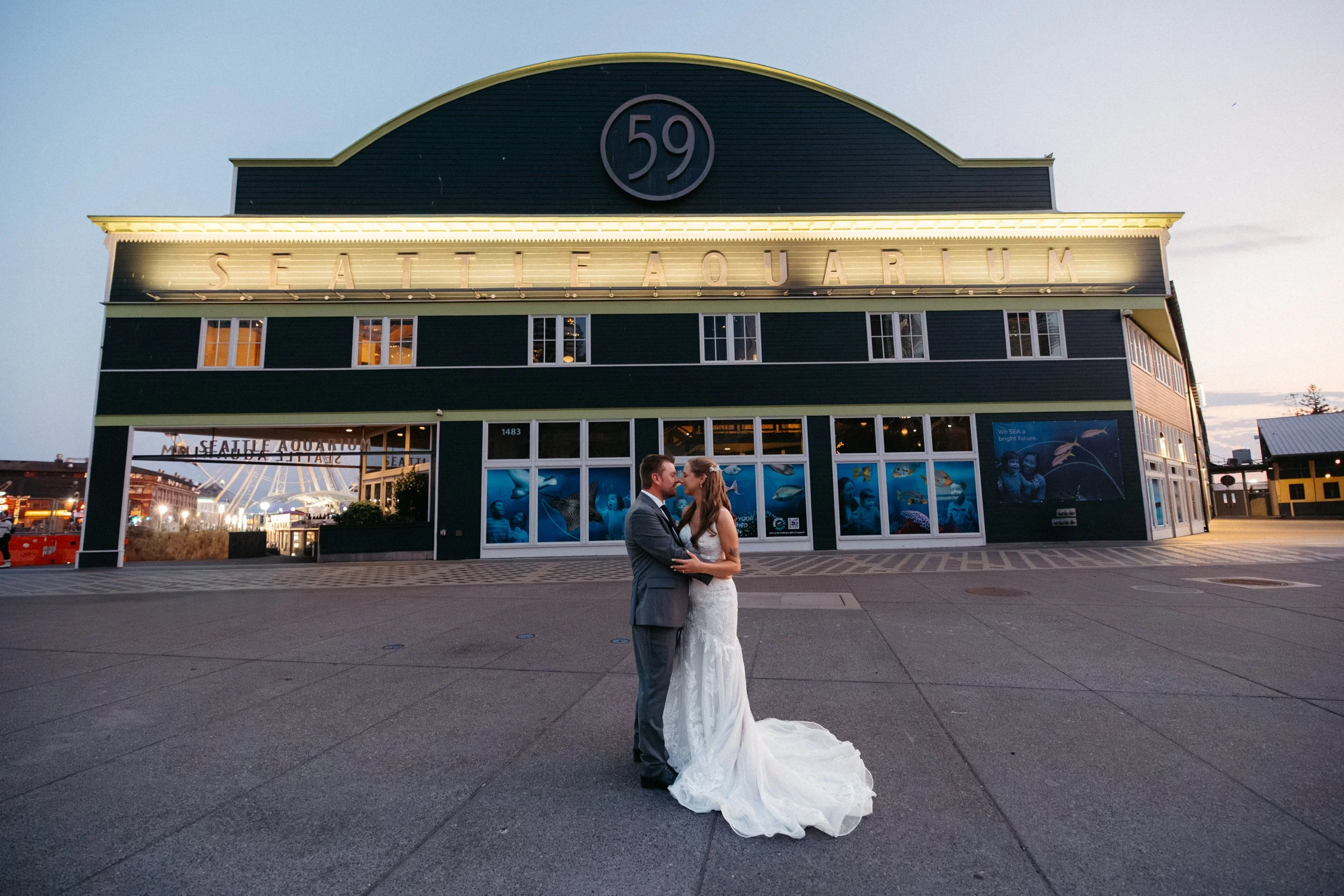 Evening wedding portraits outside the Seattle Aquarium in Seattle.