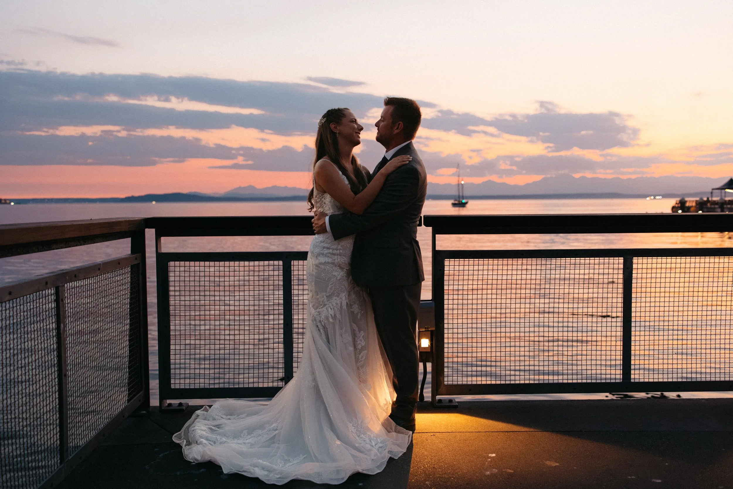 Sunset wedding couple portraits on the Seattle Waterfront near the Seattle Aquarium.