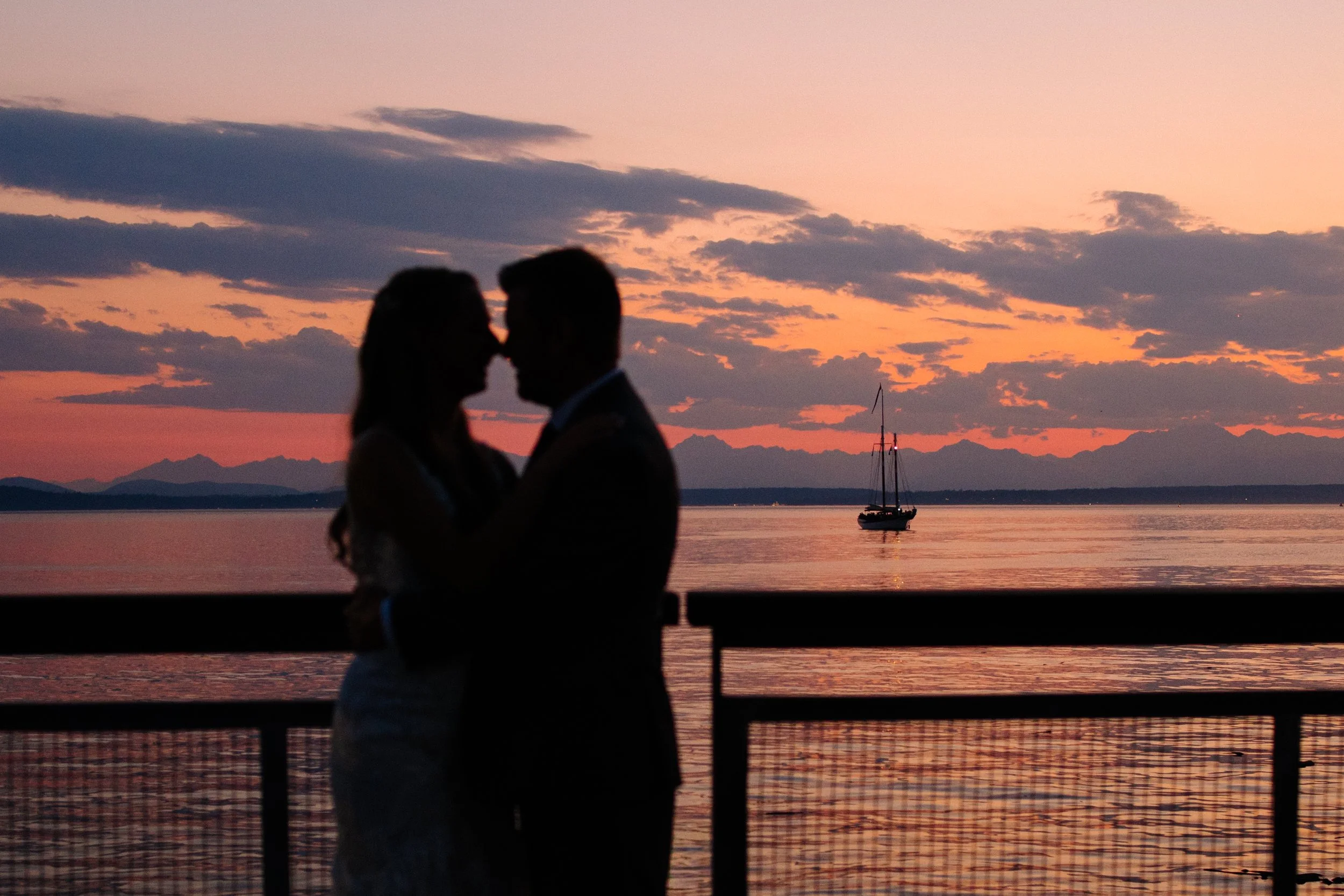 Sunset wedding couple portraits on the Seattle Waterfront near the Seattle Aquarium.