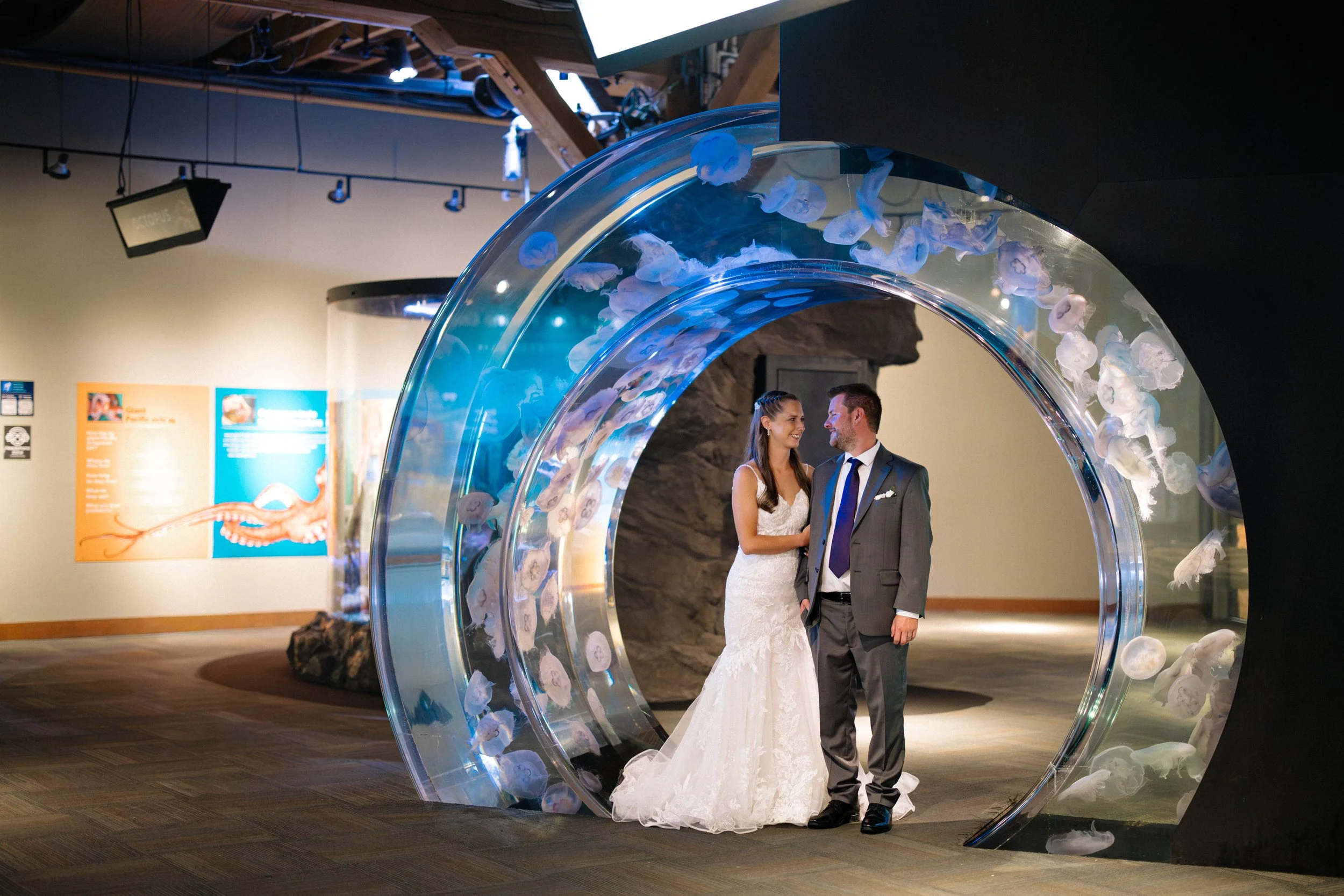 Wedding portraits inside the Seattle Aquarium jellyfish tunnel.