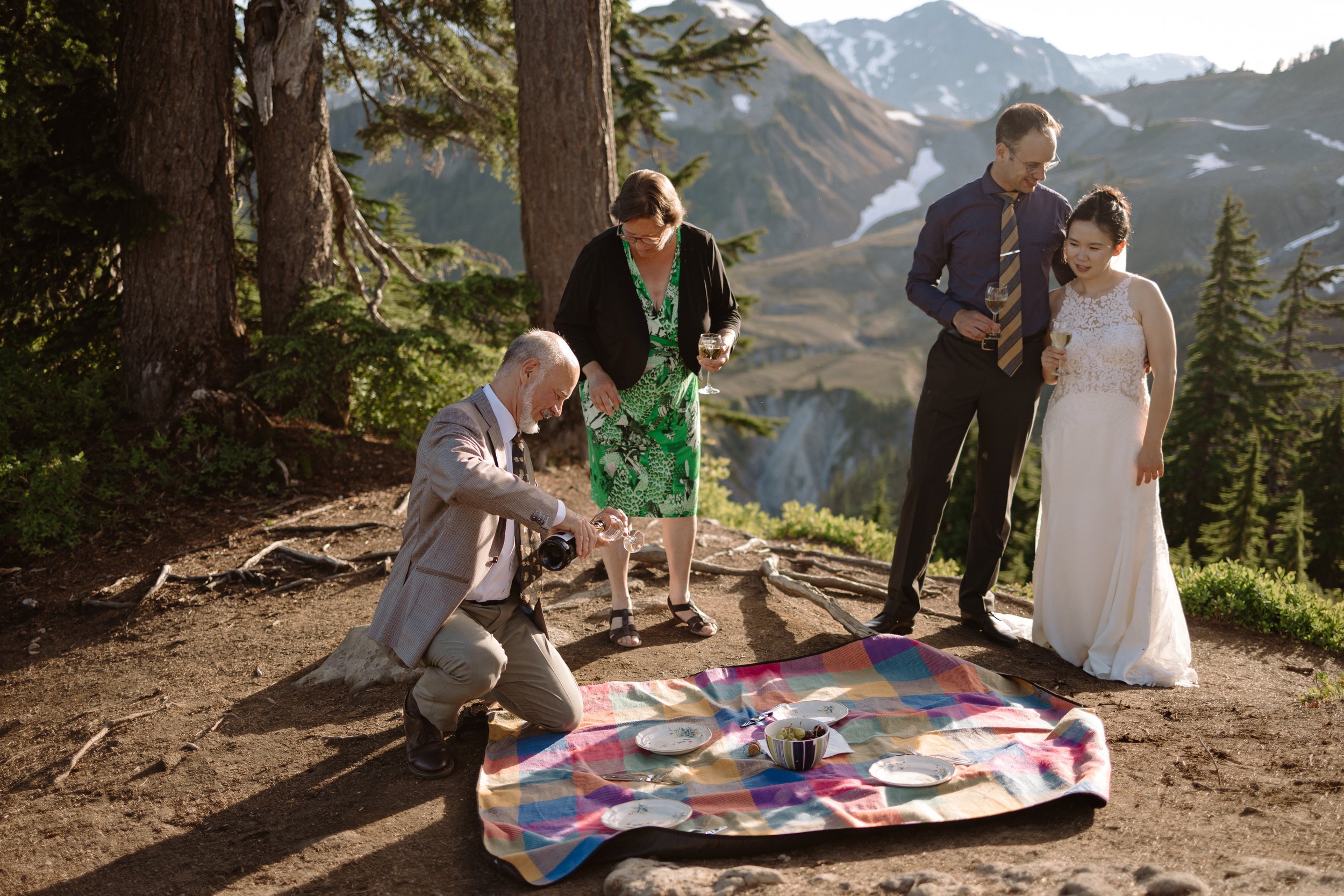 Couple and their family enjoying the picnic after their elopement at Artist Point in the North Cascades, Washington.
