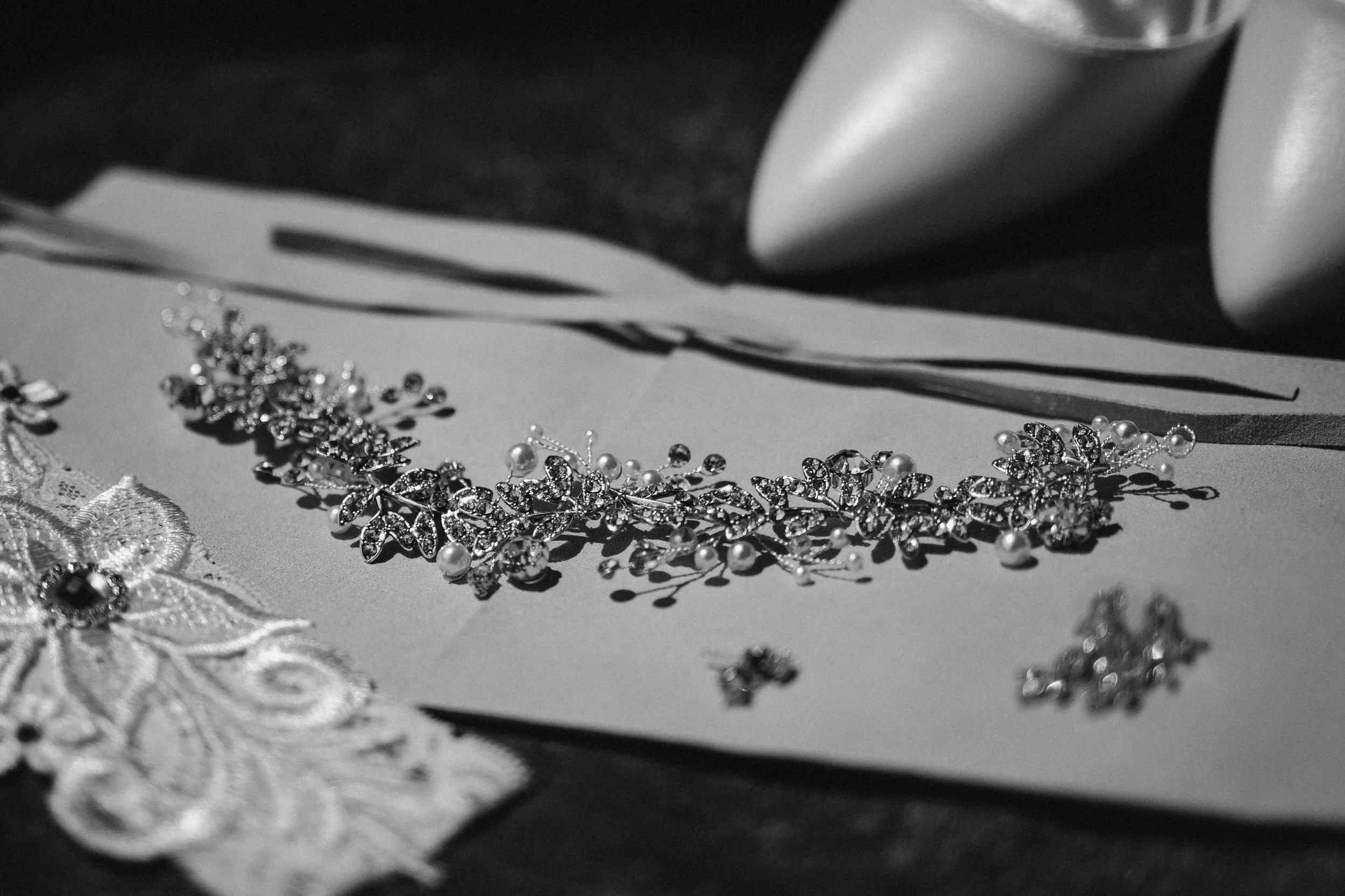 Bridal jewelry photographed during wedding preparation.