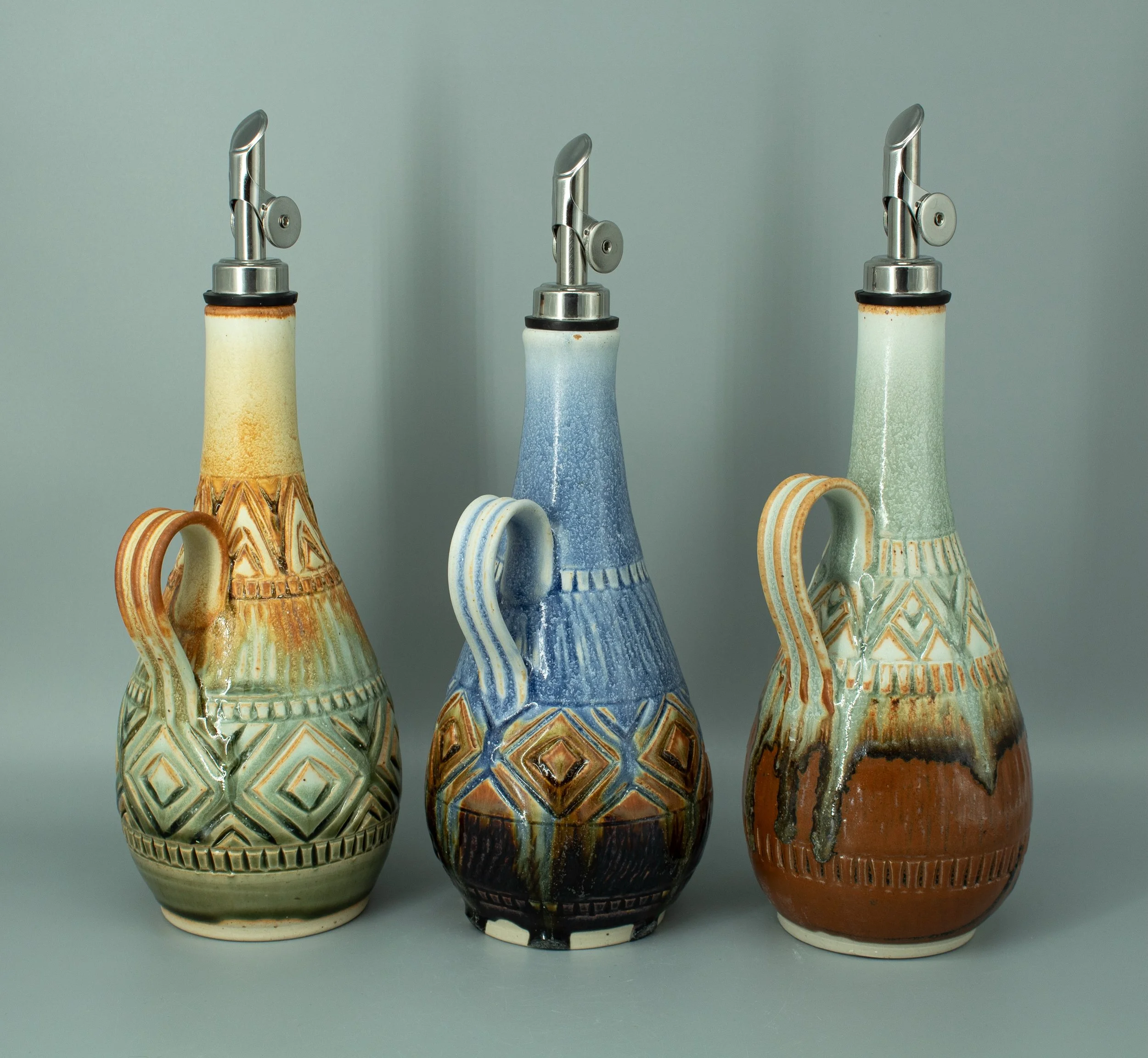 New oil bottle shape!!🙌

Completely obsessed with how these turned out and the way the glaze moves over the carved surfaces. This bellied-out form gives me so much more area to play with carving designs compared to my more cylindrical bottles, and I