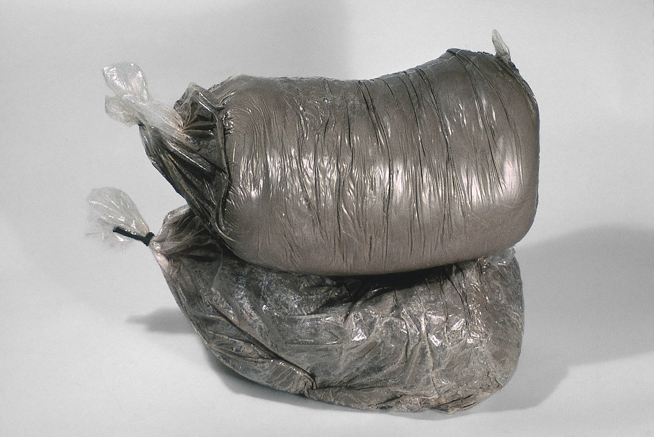 Pre a, 1969, unfired clay in bag