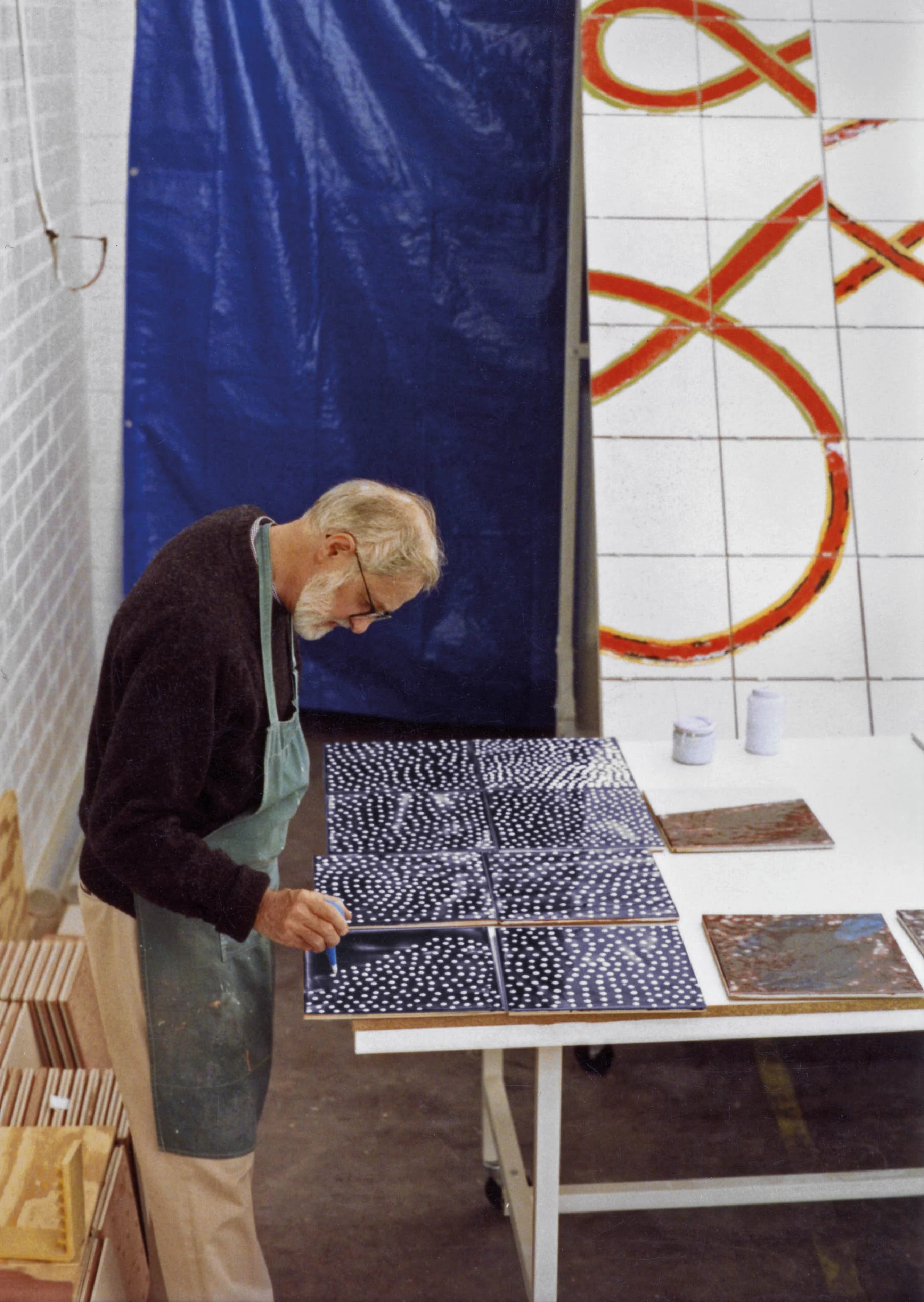 Jim Melchert painting tile for Coming to Light at the Tile Guild, Los Angeles, California, 1990
