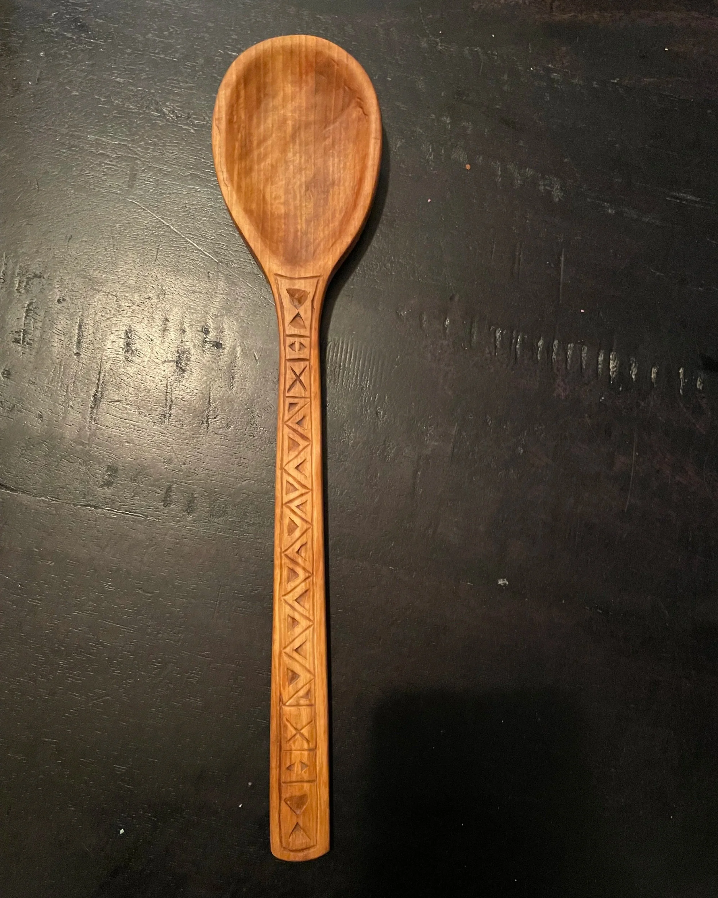 Pear serving spoon chip-carved lines and triangles.