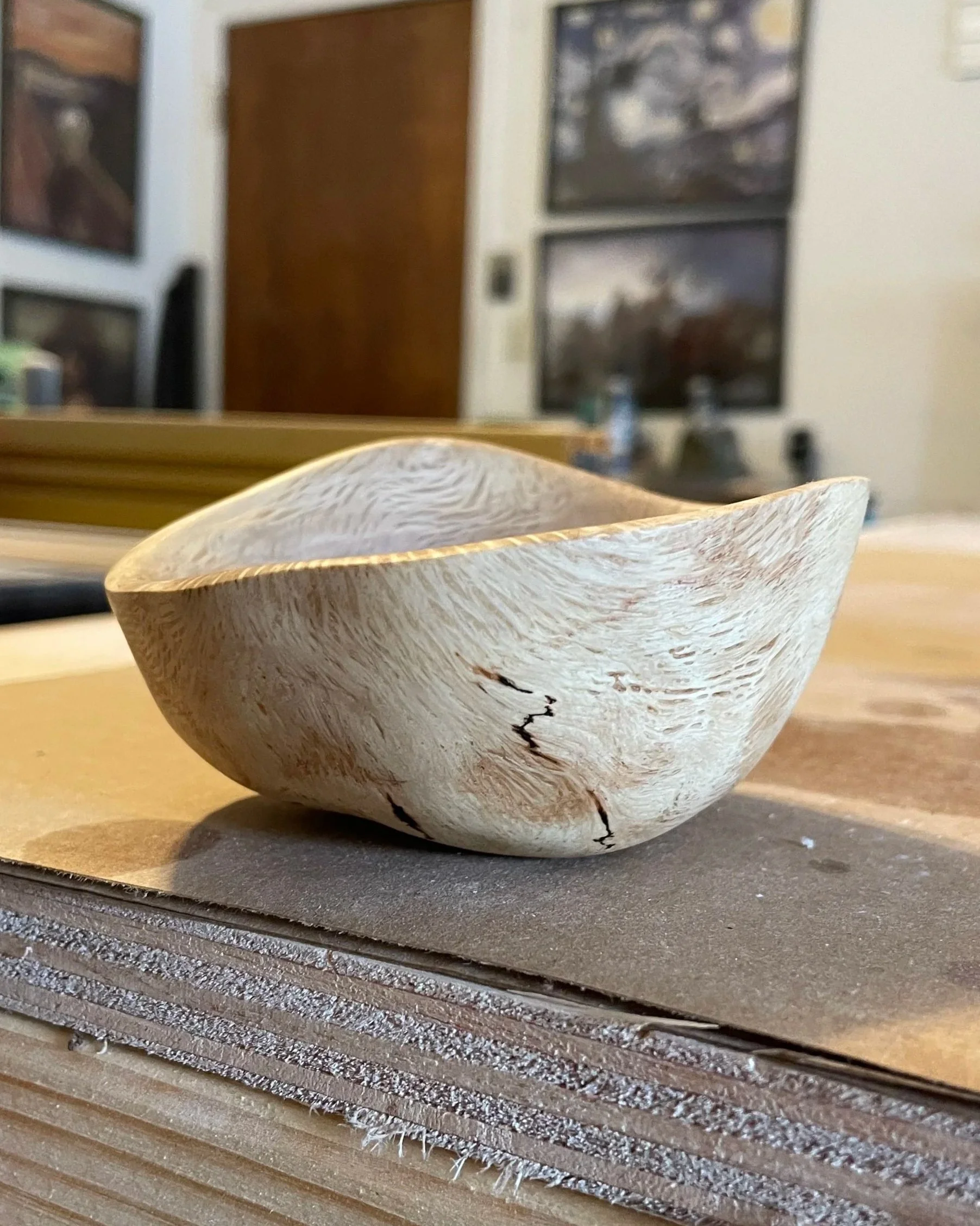 Oak bowl with irregular, swooping sides.