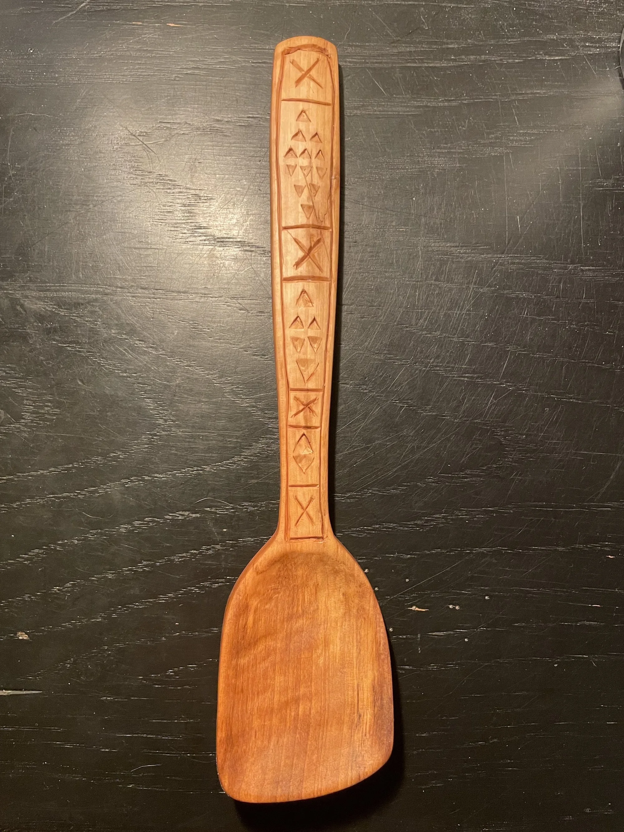 Pear cooking spoon with chip-carved triangles and runes.