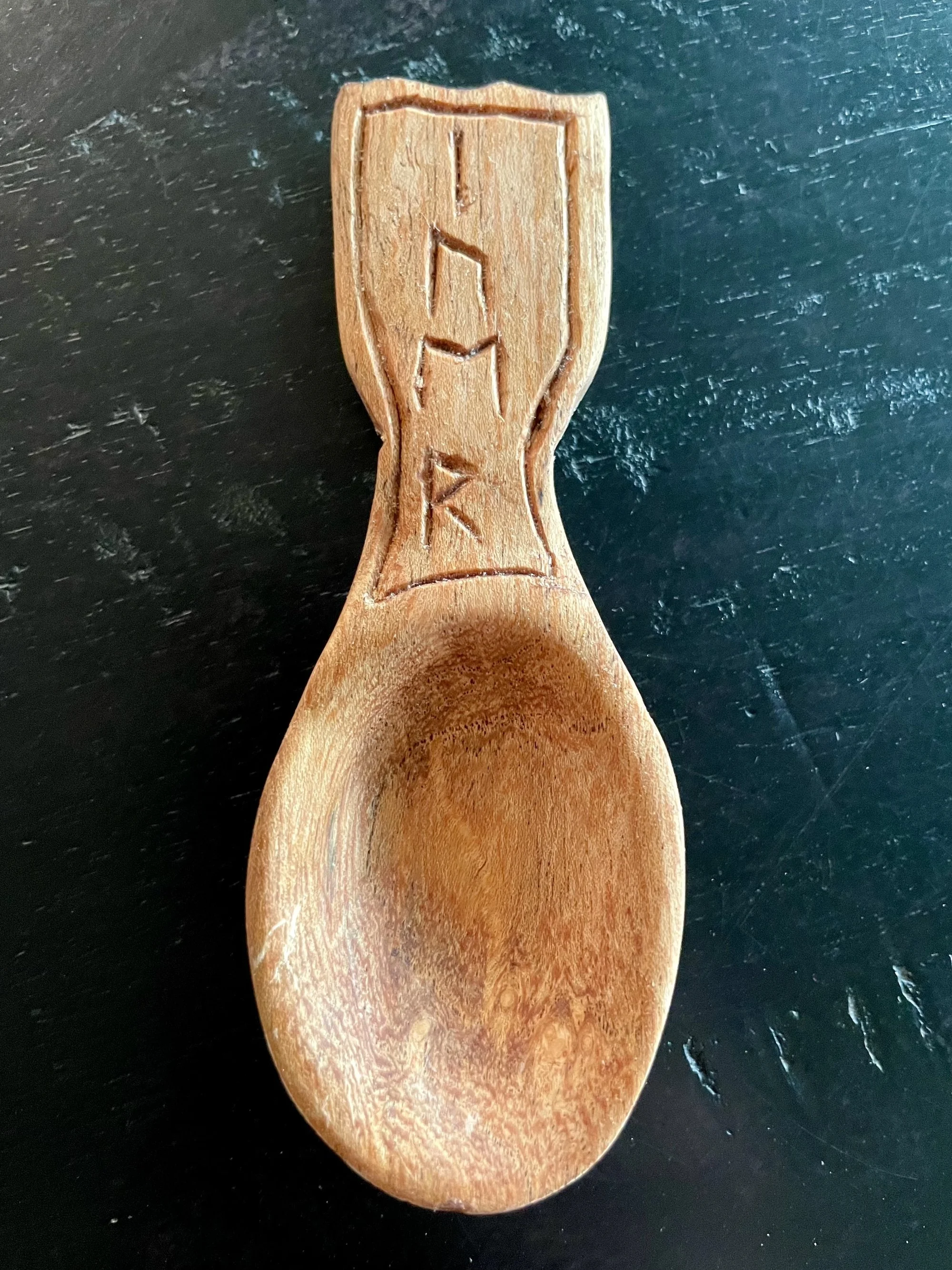 Mesquite baby spoon with hand-carved runes.