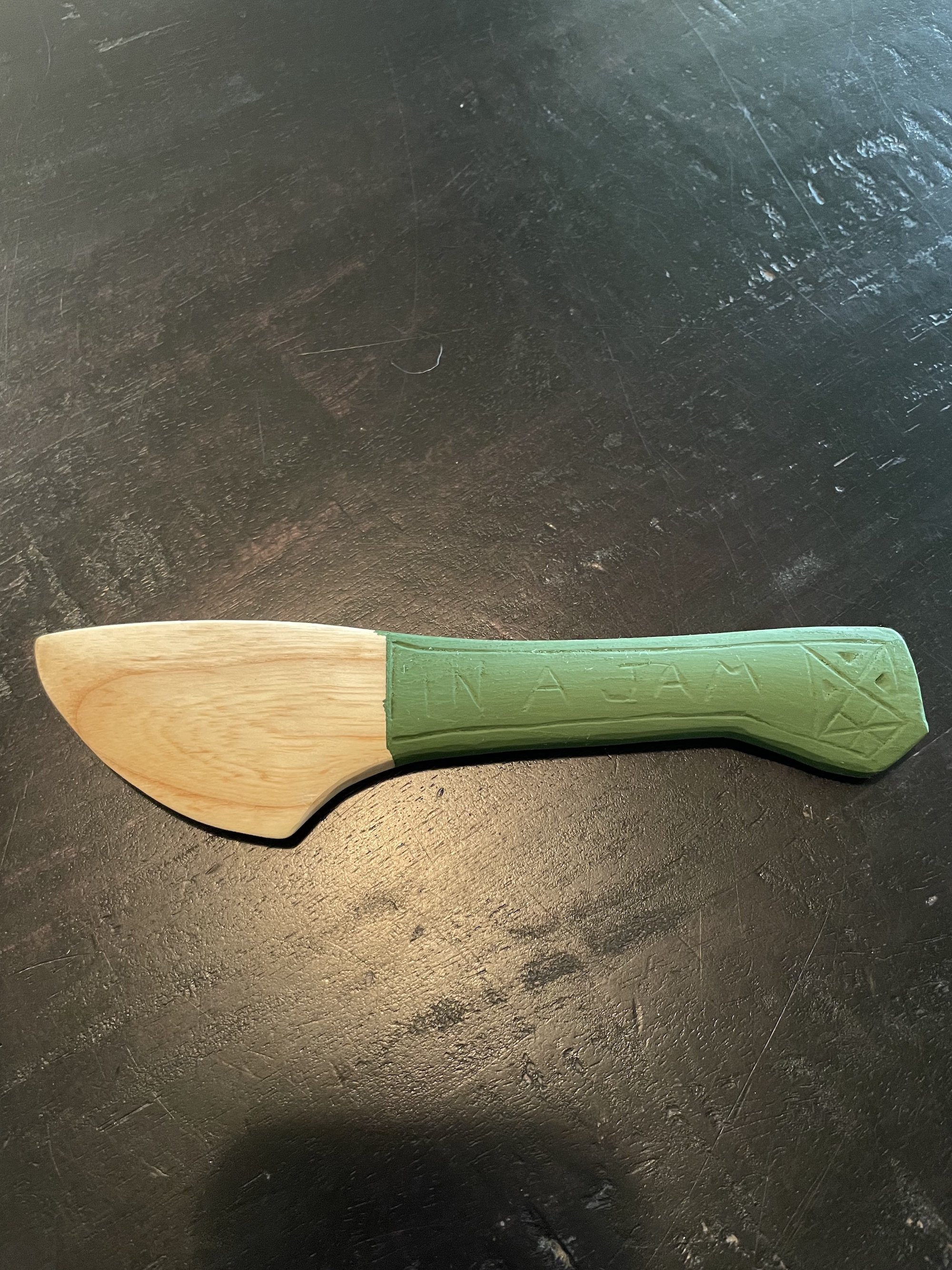 Magnolia butter/jam spreader with "In a Jam" carved into one side. Finished with green milk paint.