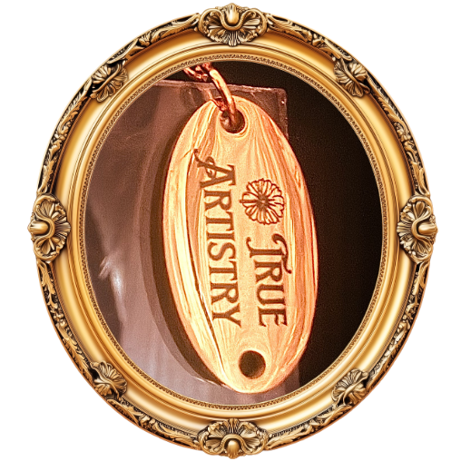A close-up of a wooden tag hanging inside a decorative gold-colored frame, with the words 'True Artistry' engraved on it.