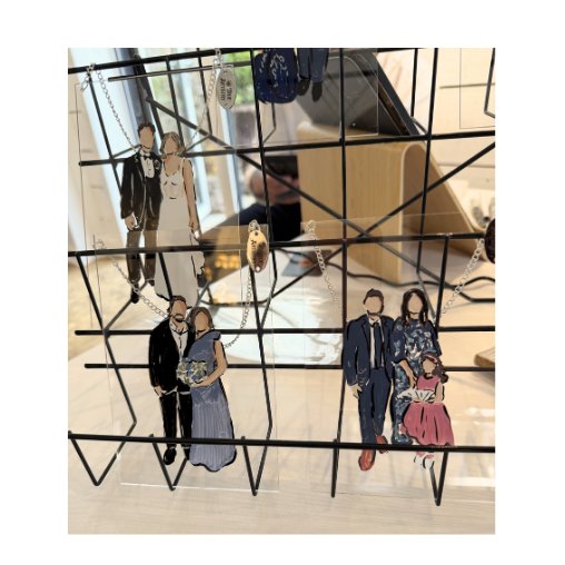 Decorative wire display with live wedding illustrations, including a man in a suit, a woman in a dress, and a child in a pink outfit, visible through a grid-like structure.