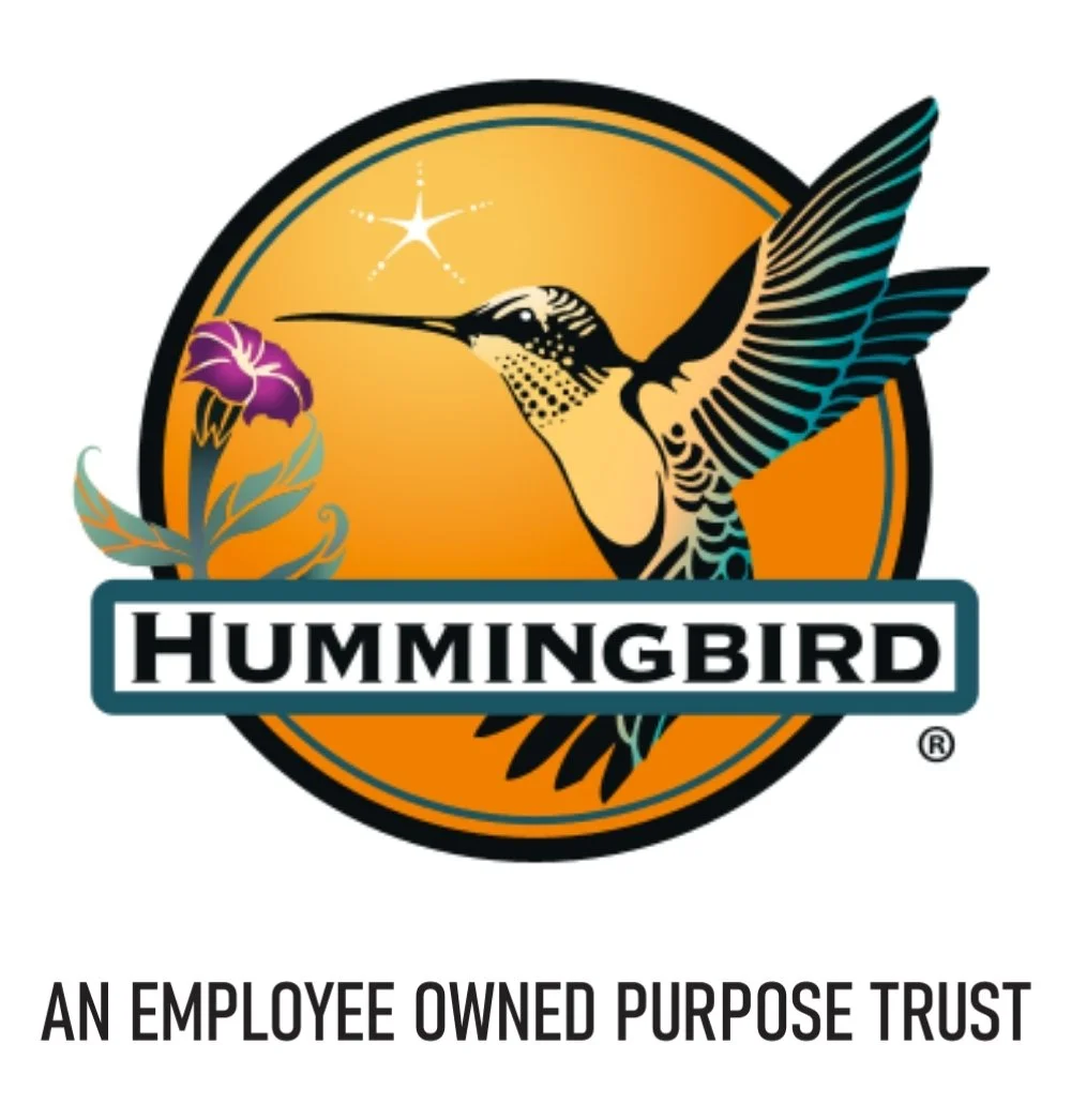 Hummingbird logo with an orange circle, a purple flower, and a star, featuring the word "Hummingbird" and the tagline "An Employee Owned Purpose Trust."
