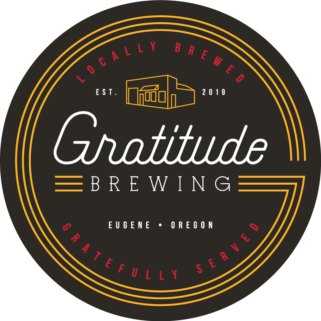 A round logo for Gratitude Brewing in Eugene, Oregon, featuring a black background, orange and red text, and a stylized outline of the brewery building at the top center.