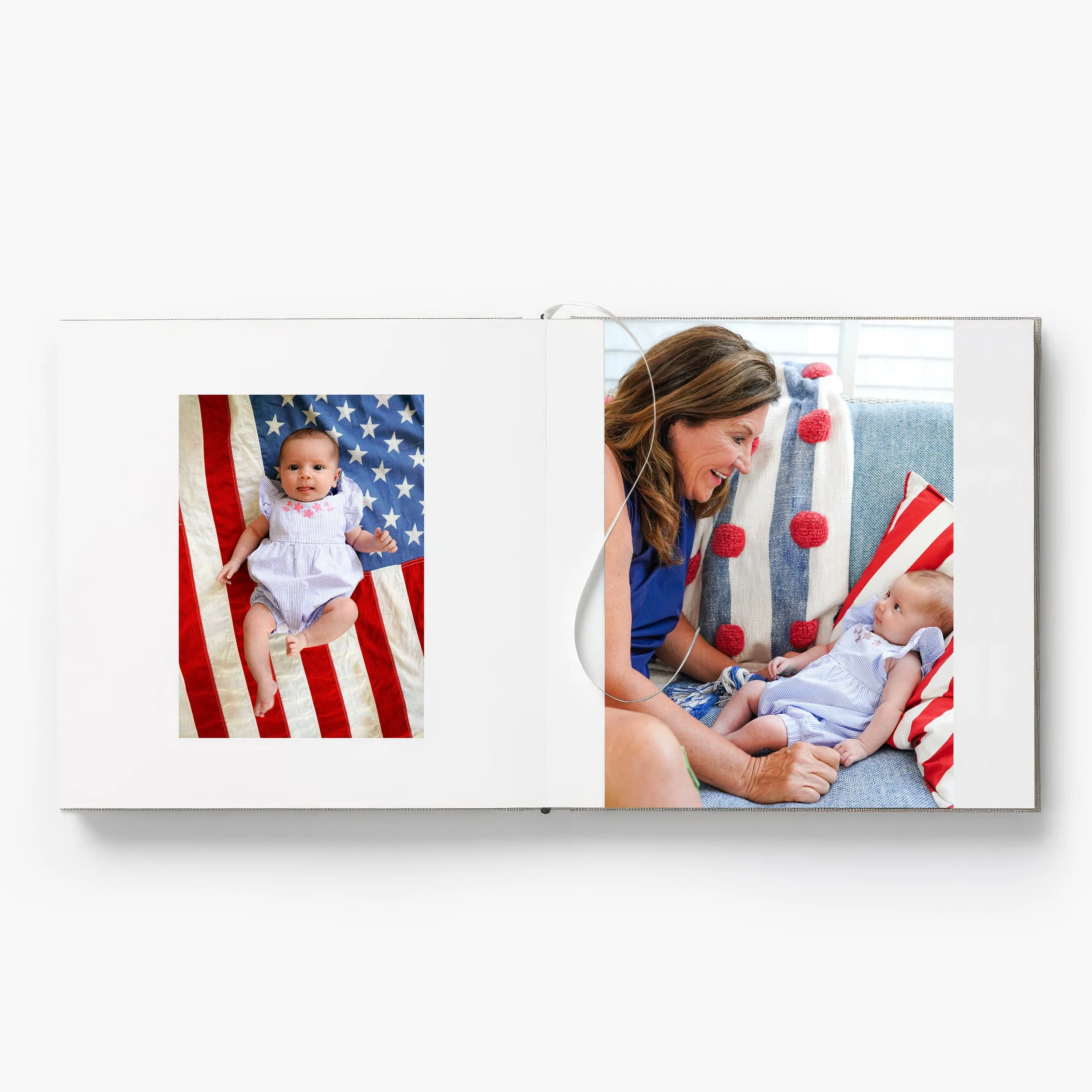 Photo of a woman with brown hair smiling while sitting with a baby in a blue and white striped outfit, surrounded by patriotic red, white, and blue decorations and American-themed pillows.