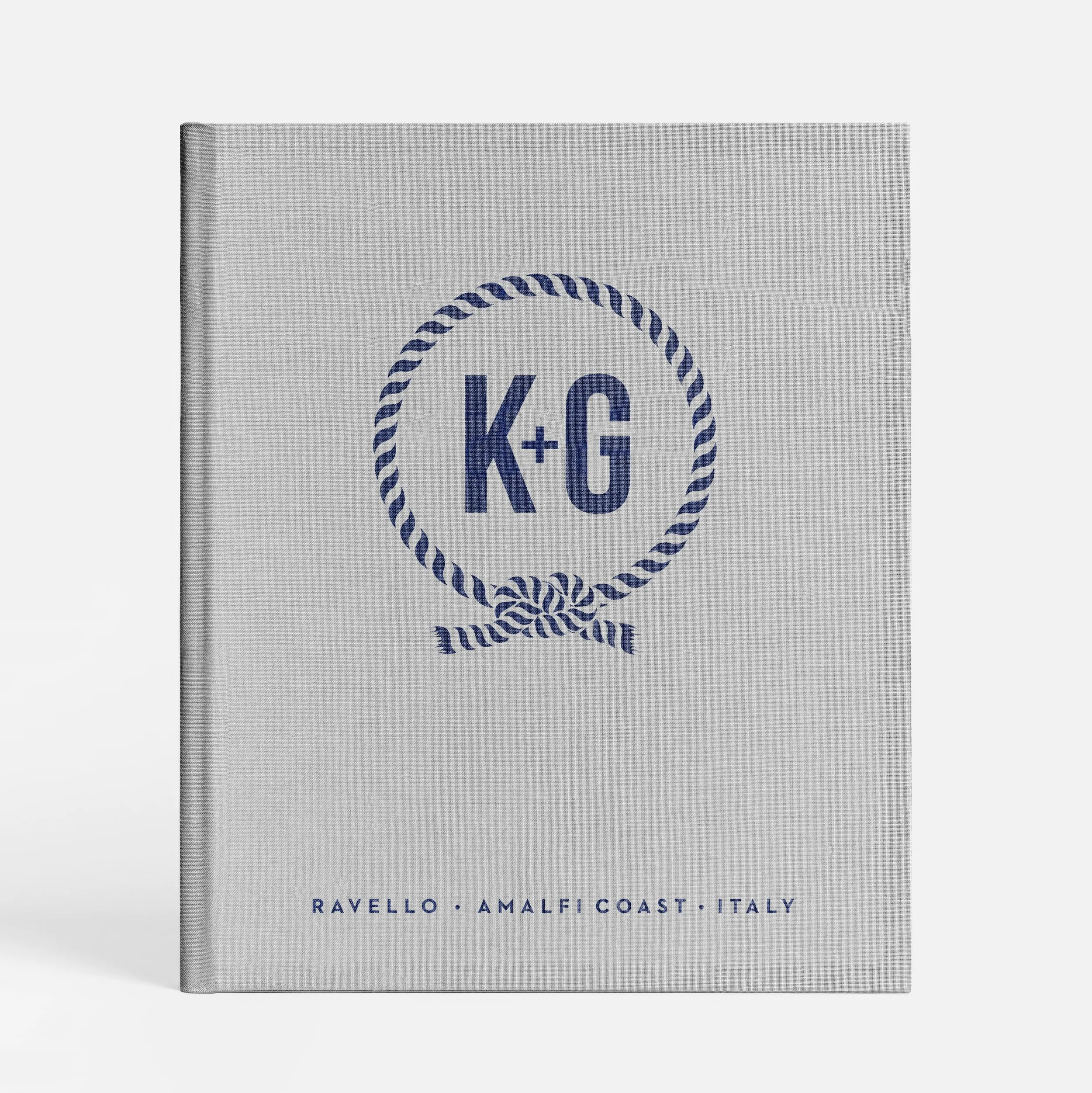 A white booklet or brochure with navy blue text and design, featuring the text 'RAVELLO - AMALFI COAST - ITALY' and a circular rope design with the letters 'K+' inside.