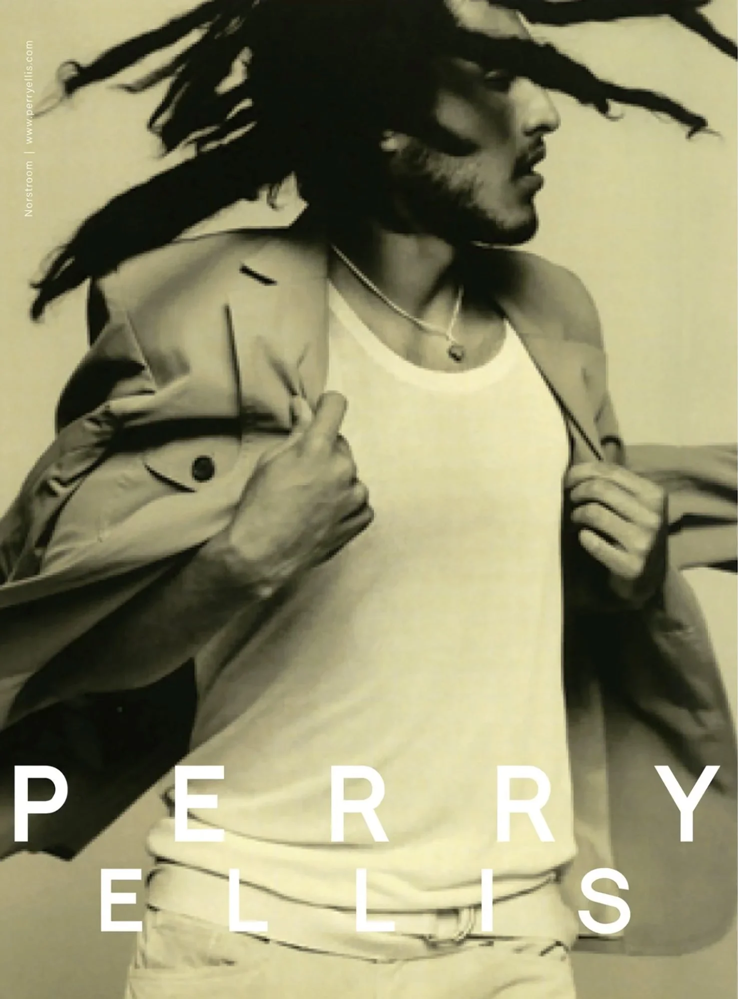 Black and white image of a man with dreadlocks, shirtless, wearing a necklace and a hoodie, with his hands close to his chest, and the phrase 'PERRY ELLIS' overlaid at the bottom