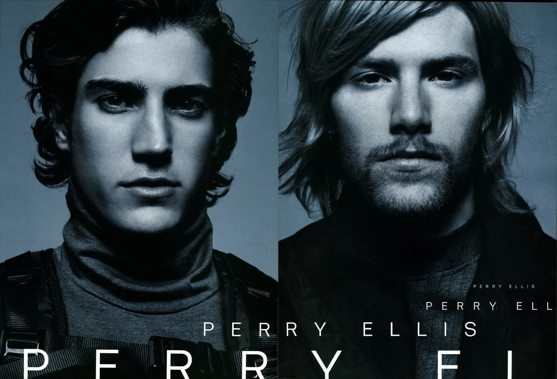 Promotional poster featuring two men with the text "Perry Ellis" at the bottom, side by side in black and white.