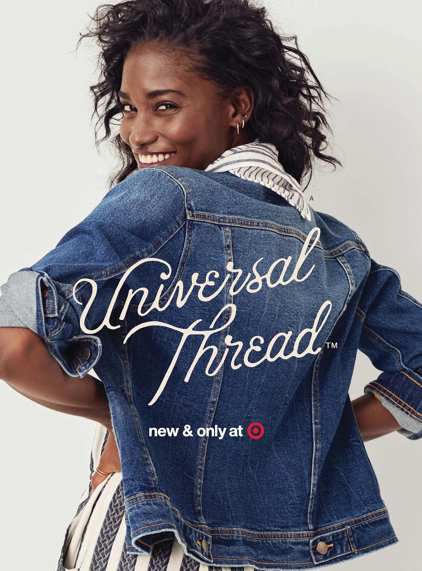 A woman with curly hair smiling, wearing a denim jacket over a striped shirt, with text overlay that reads "Universal Thread," and a notice that says "new & only at Target."
