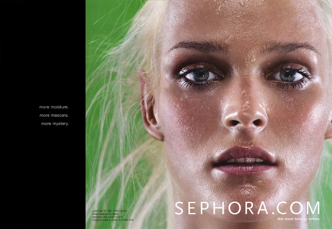 Close-up of a woman's face with makeup, moist skin, and a green background, promoting Sephora.com.