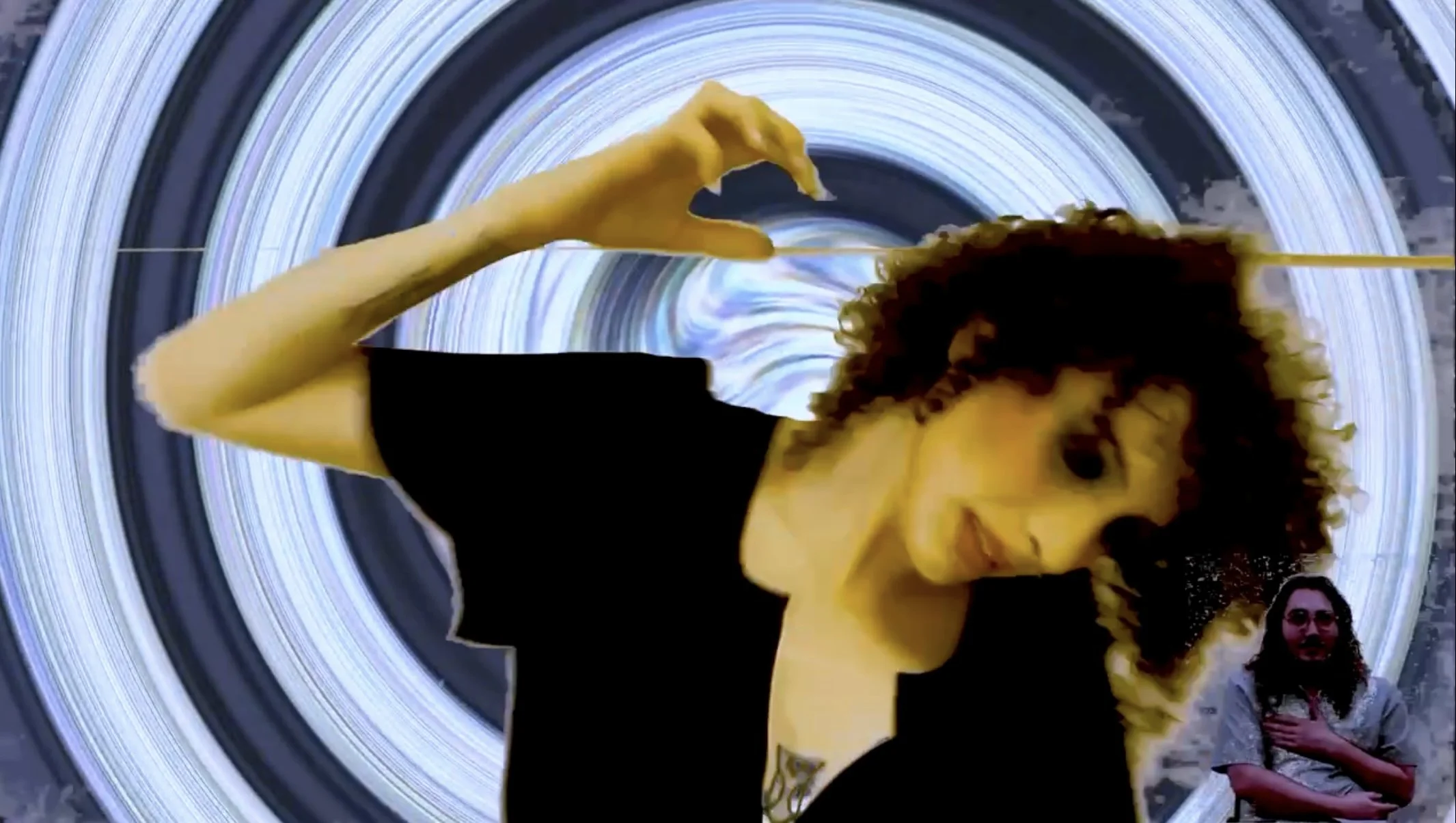 A person with curly hair wearing a black shirt appears to be spinning in a vortex or tunnel effect, with a figure of another person standing with arms crossed in the lower right corner.