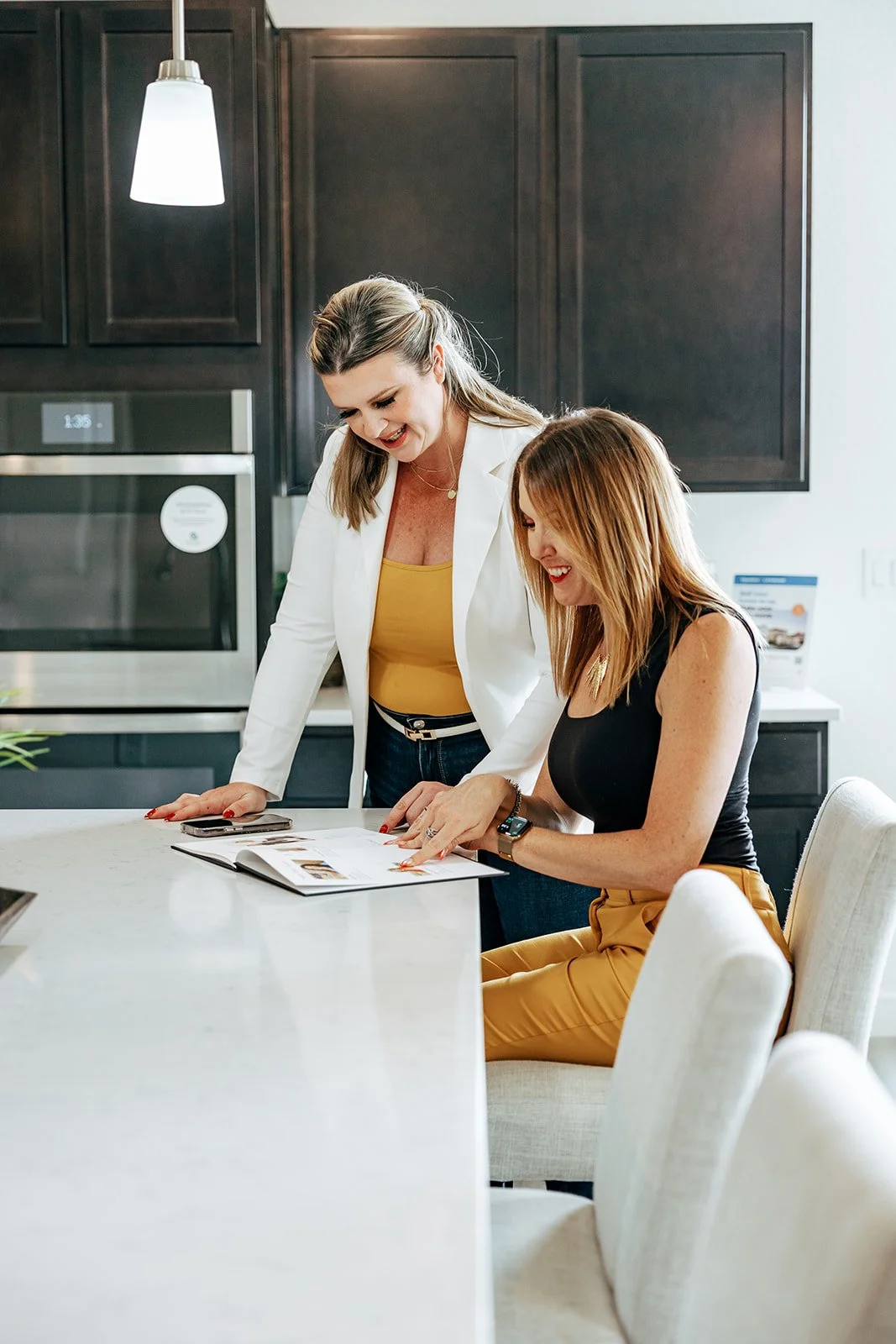 Out of Office real estate team, looking at realtor listings at an open house