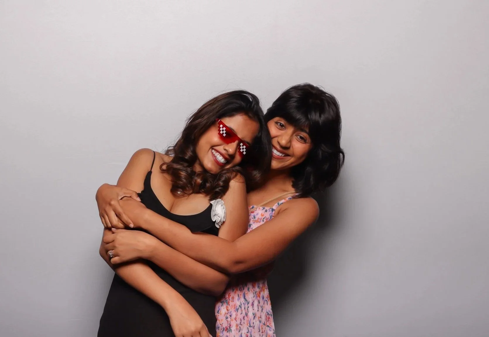 graduate students posing in front of a white backdrop at their graduation party in berkeley