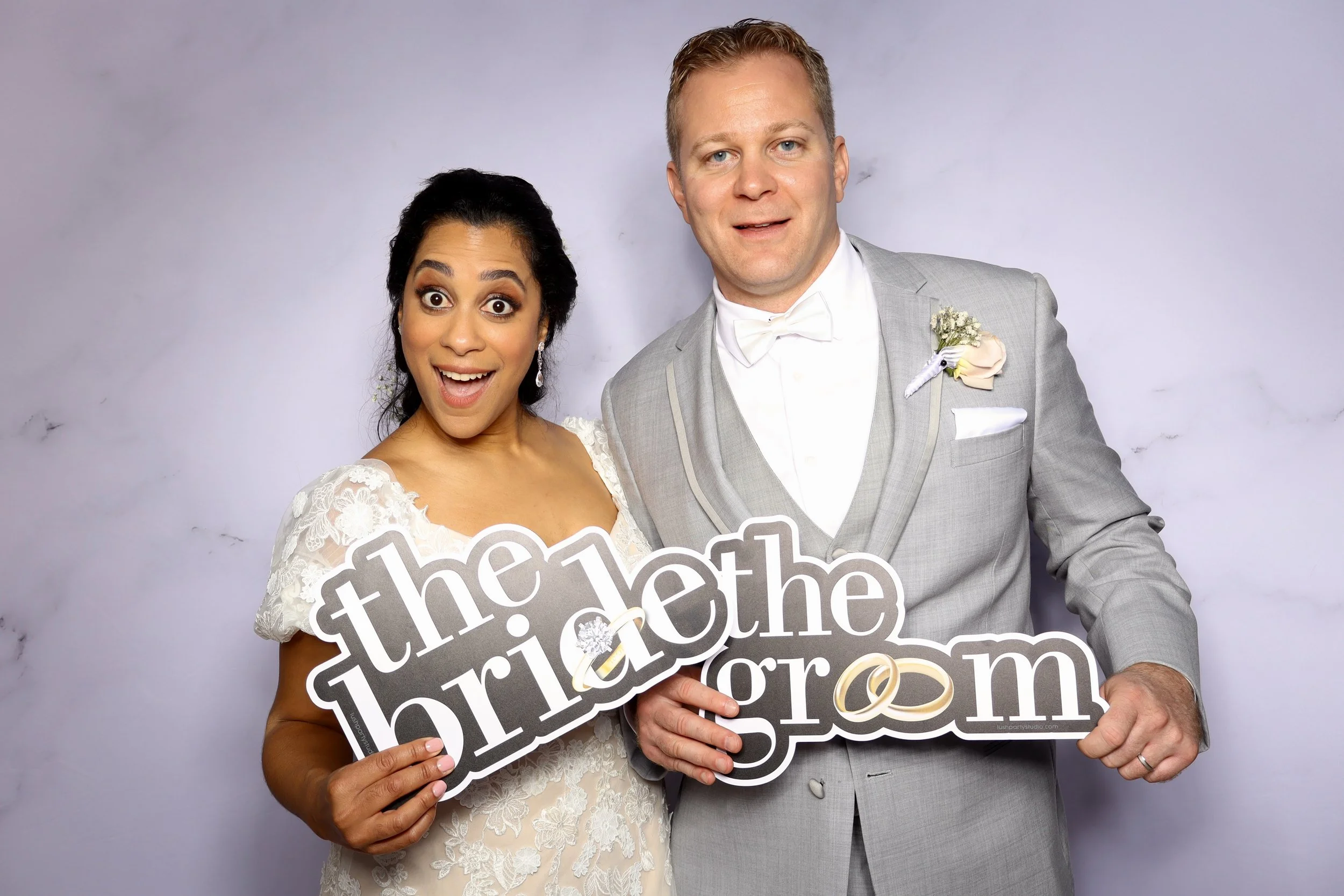 groom and bride posing with the photobooth and LenseCapture wedding package in palo alto