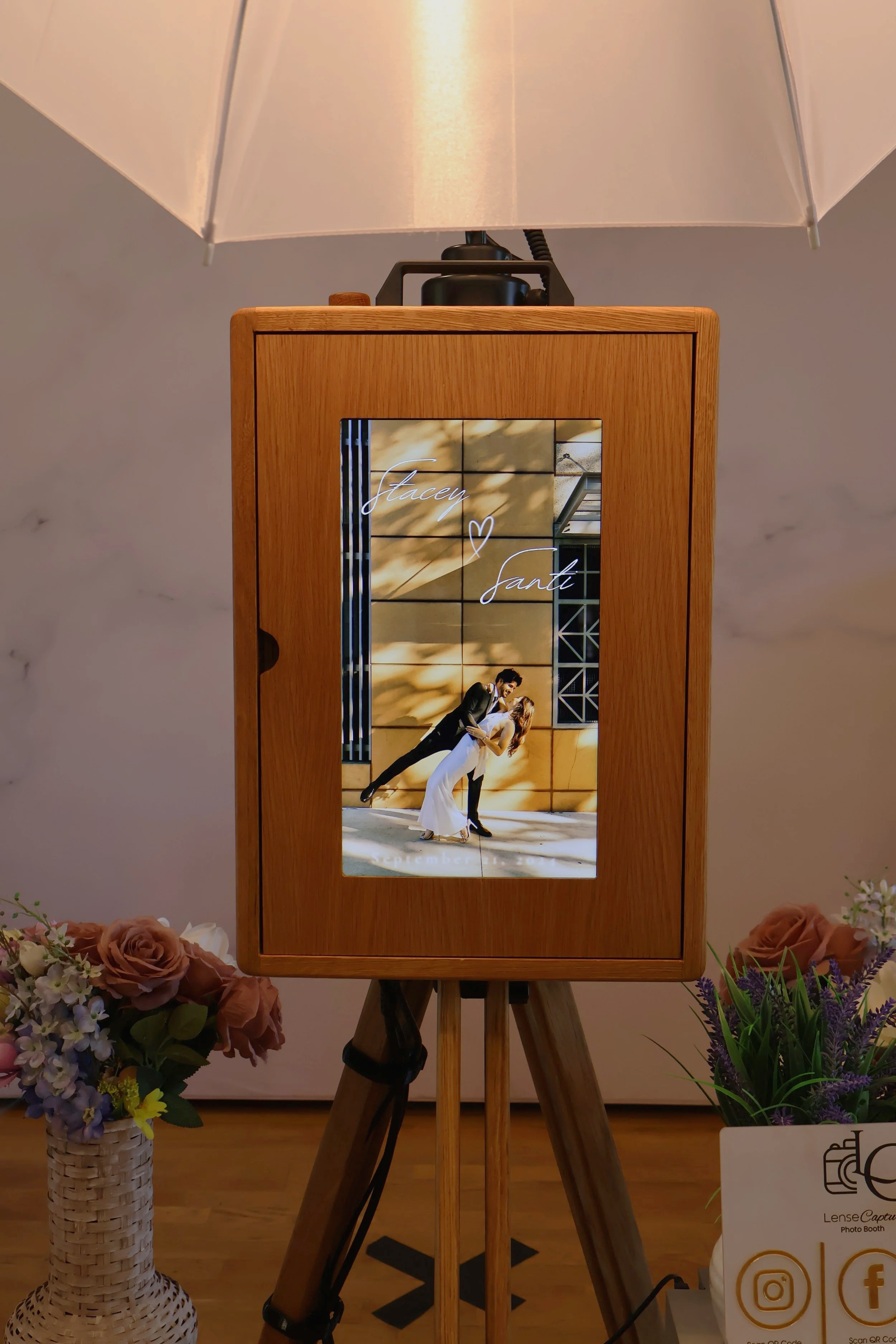 wooden photo booth in pleasant hill with a branded back screen of a wedding couple