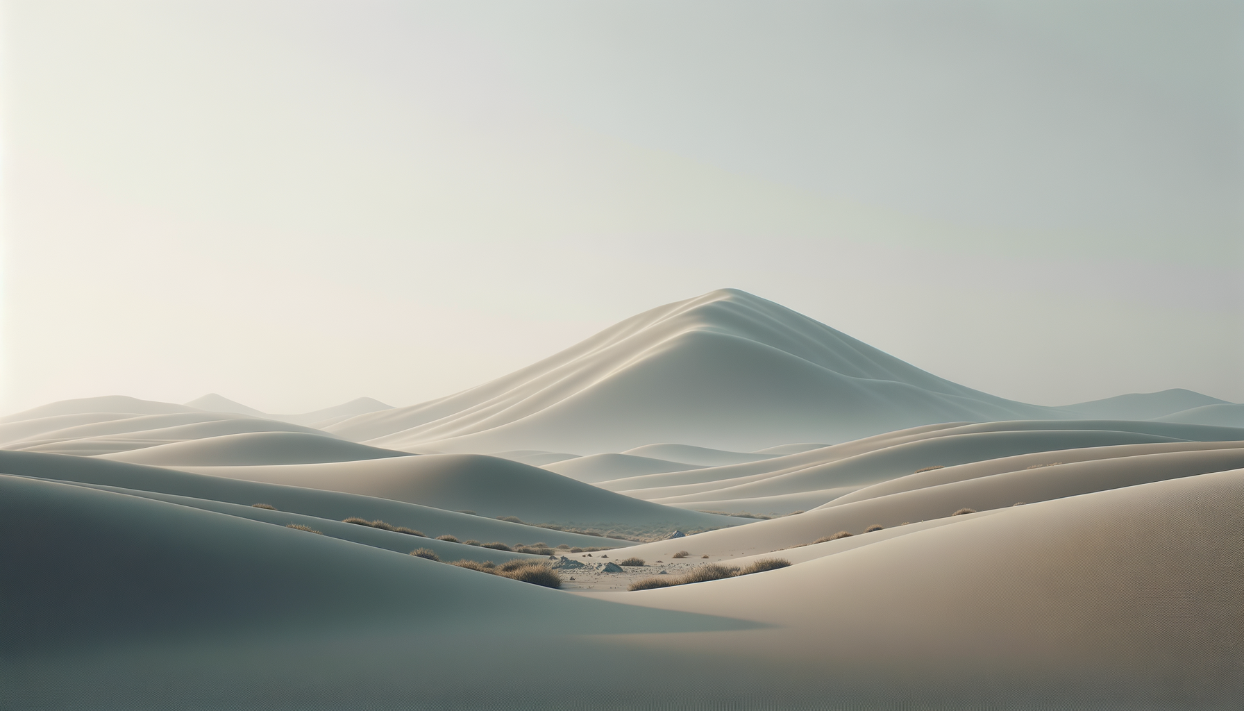 Snow-covered sand dunes under a clear sky with soft lighting.